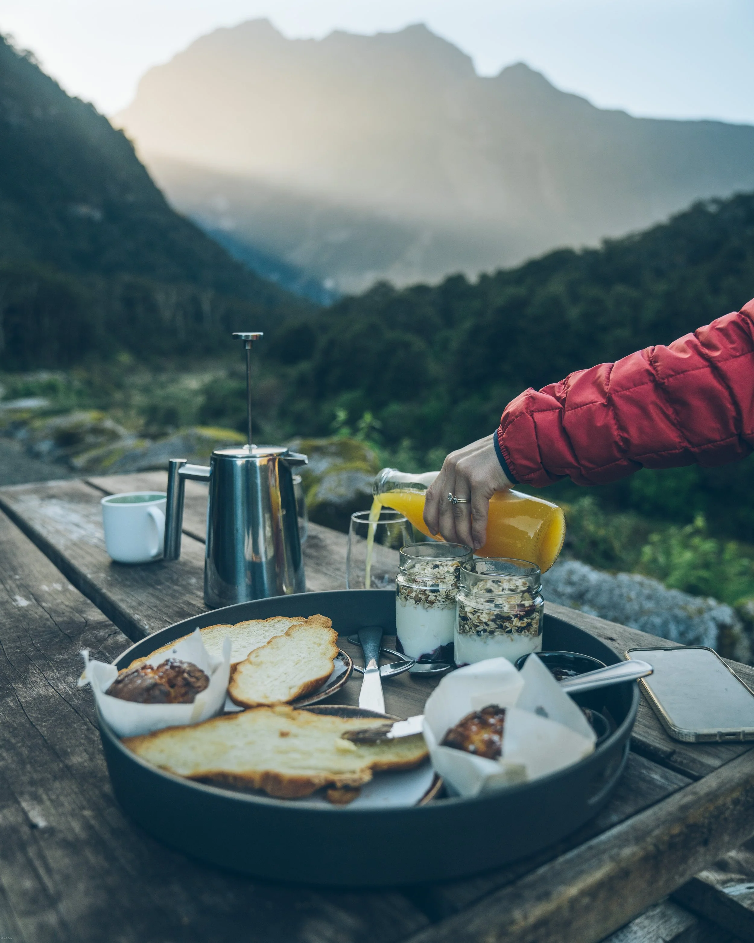 Sunrise breakfast overlooking Milford Sound from Milford Sound Lodge in Fiordland National Park, one of the most unforgettable places to stay on New Zealand's South Island.