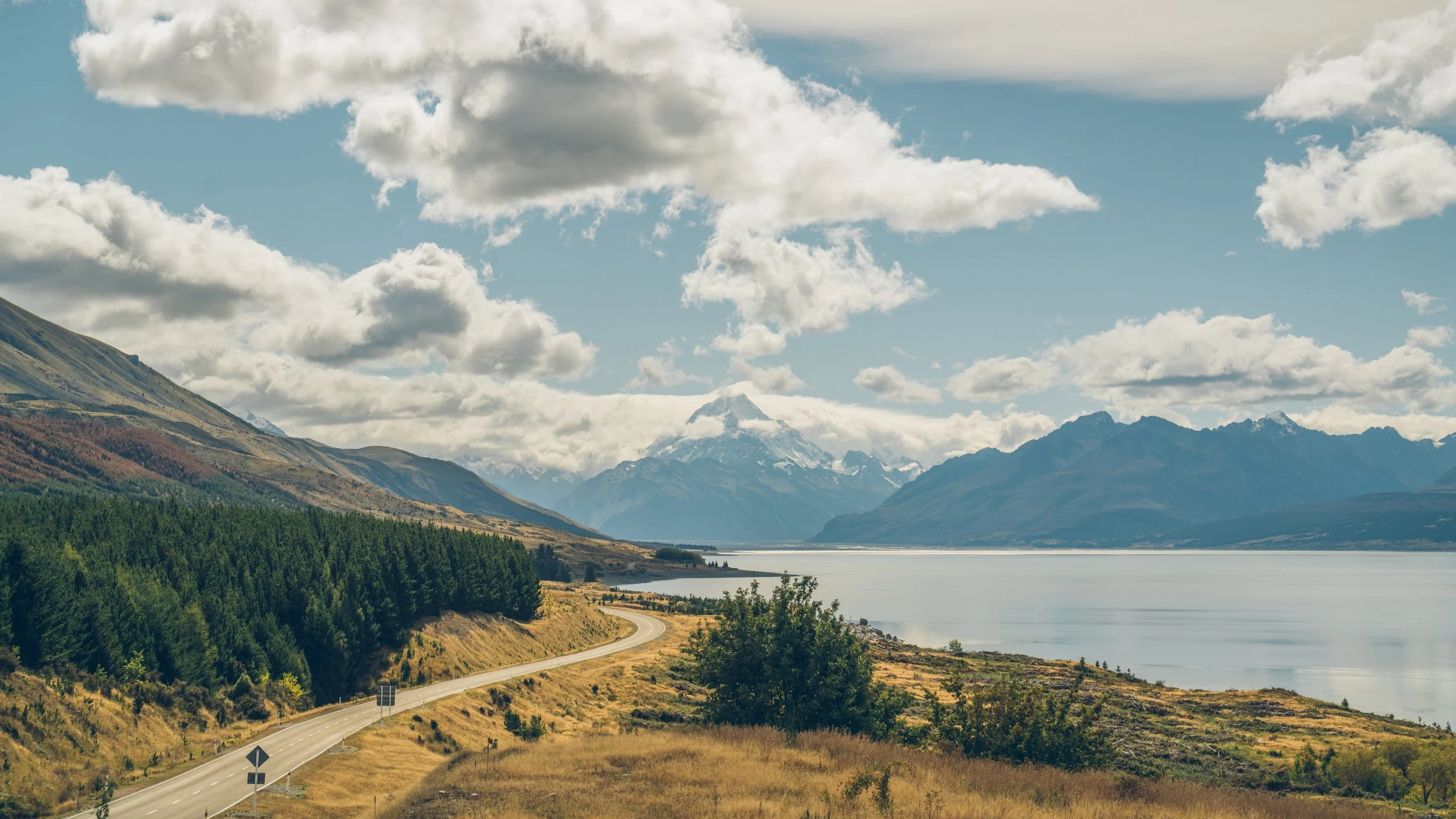 Mount Cook and it's glacier covered summit tower over Lake Pukaki in the Mackenzie Country, South Island New Zealand.  Outside of Aoraki Mount Cook National Park.