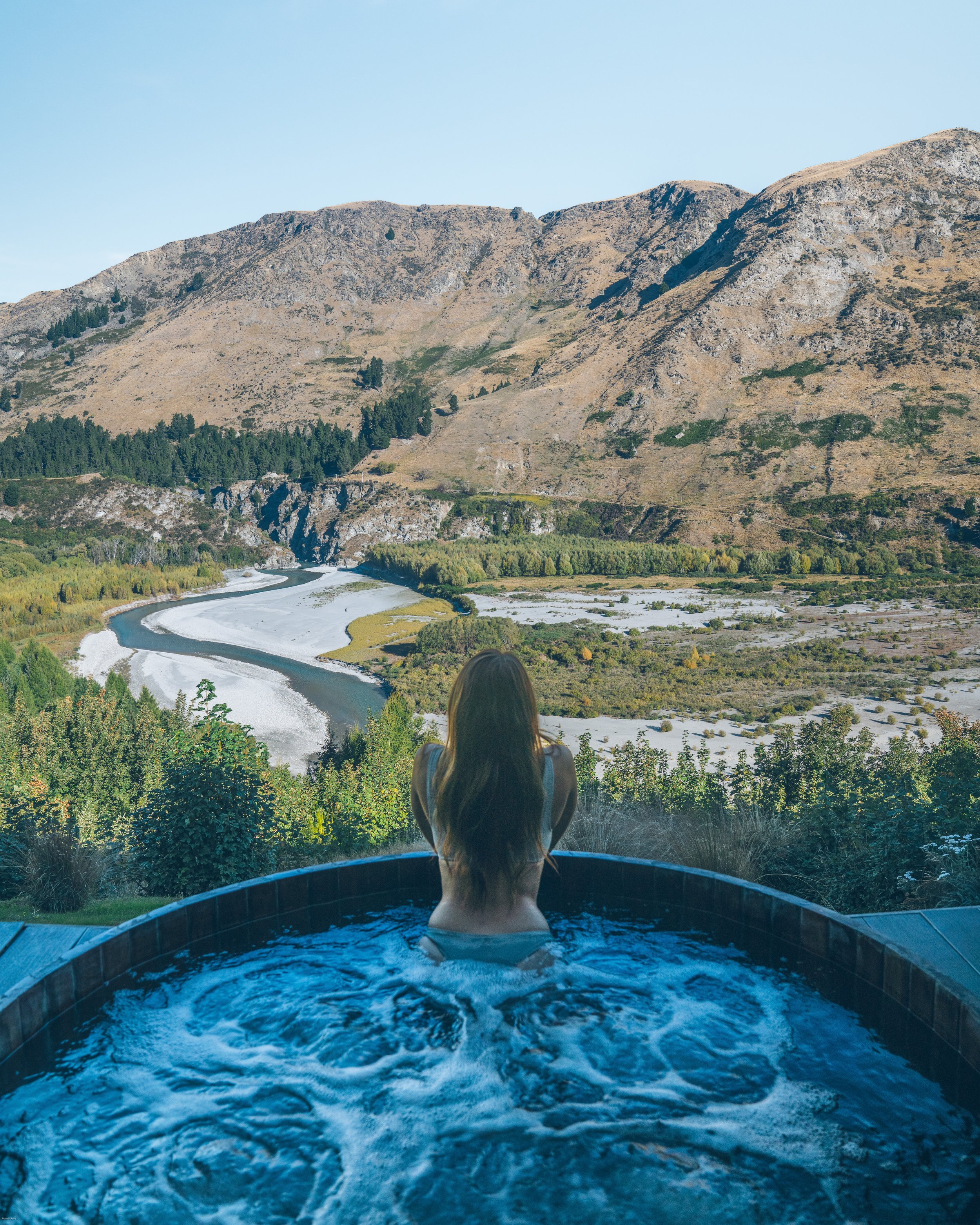 Onsen Hot Pools in Queenstown overlooking the Shotover River canyon, one of New Zealand's most iconic luxury spa experiences in Central Otago on the South Island.