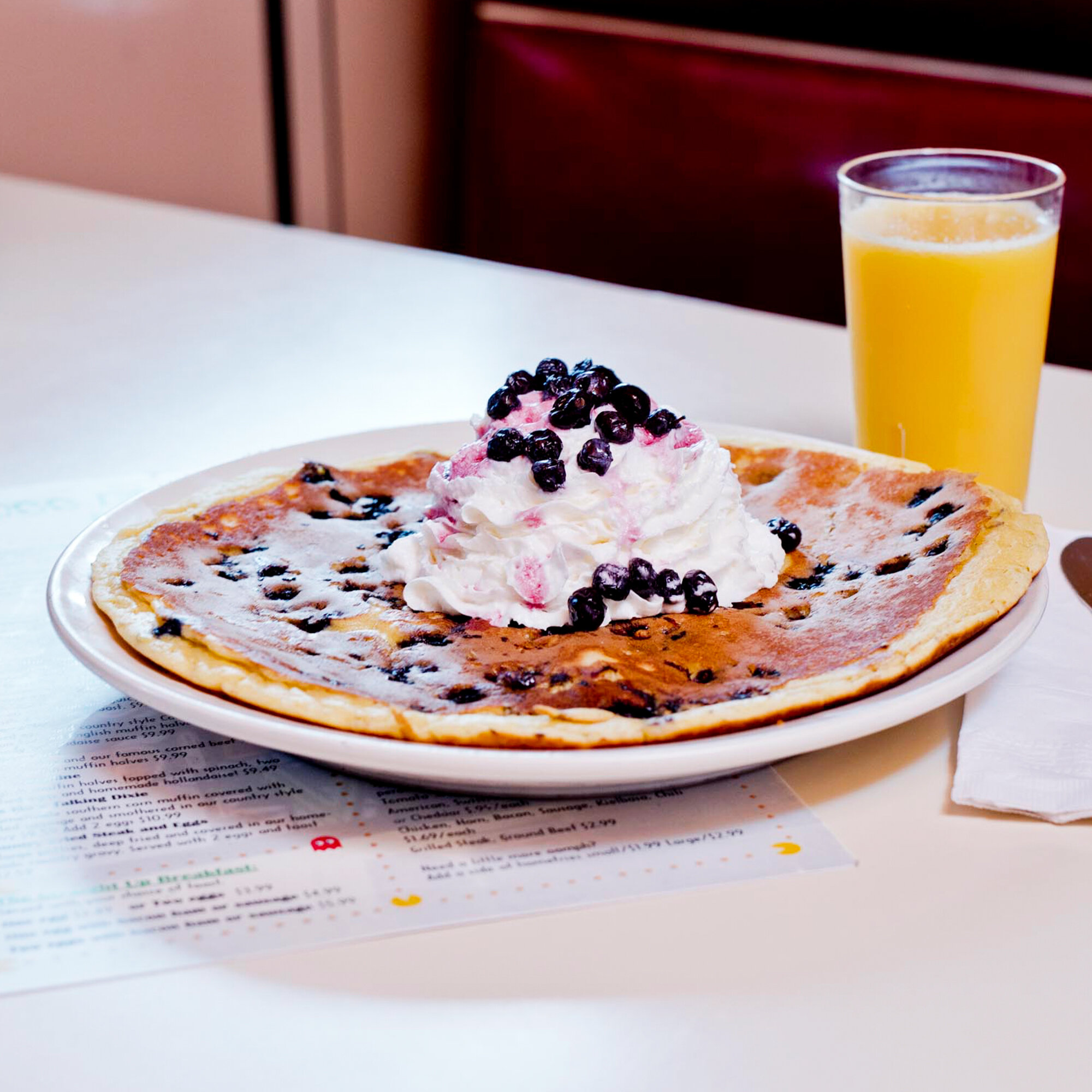  large buttermilk blueberry pancake drizzled with maine blueberries, whipped cream and maple syrup 