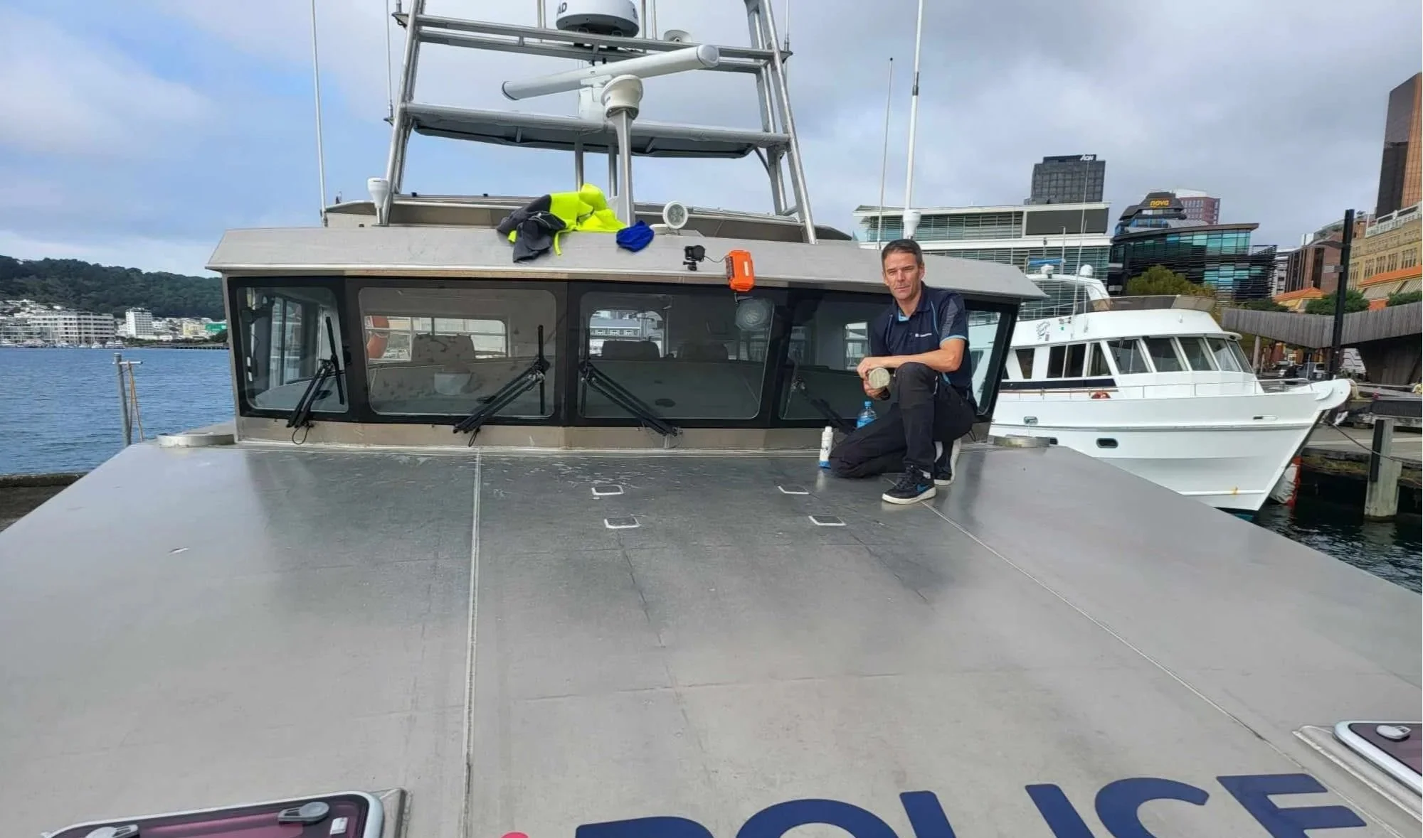 Glass restoration specialist working on marine vessel glass in Wellington marina environment