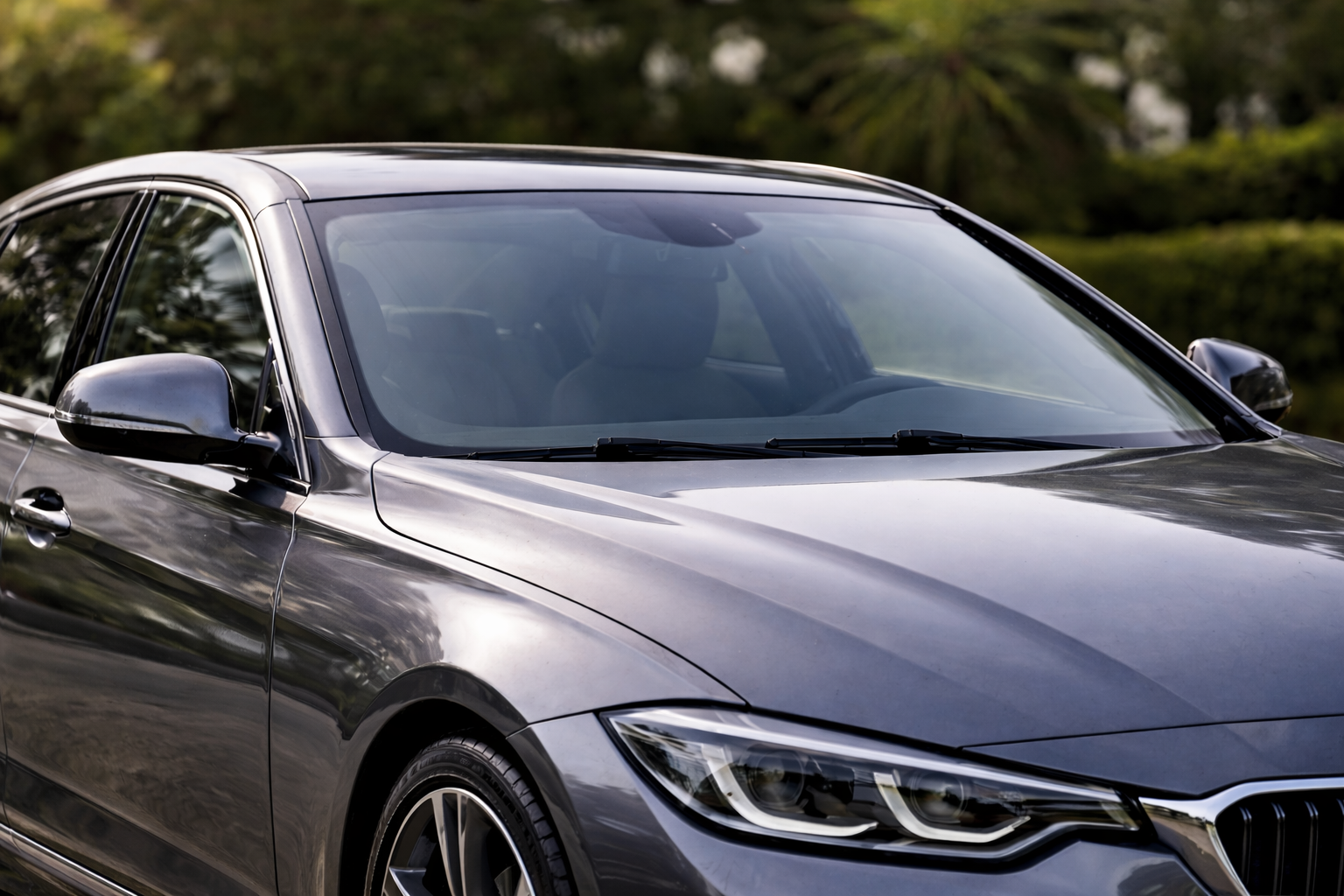 Modern sedan with clean windscreen for Nano Glass Protection vehicle care guide