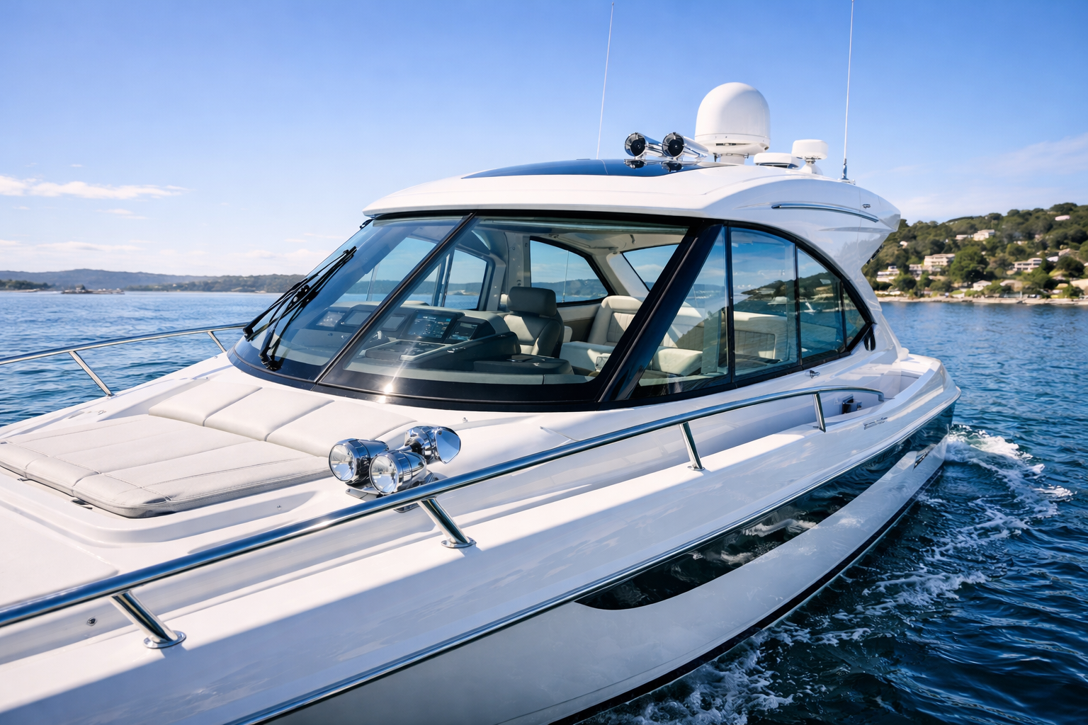 Modern cabin cruiser with clear marine windscreen protected for visibility and durability