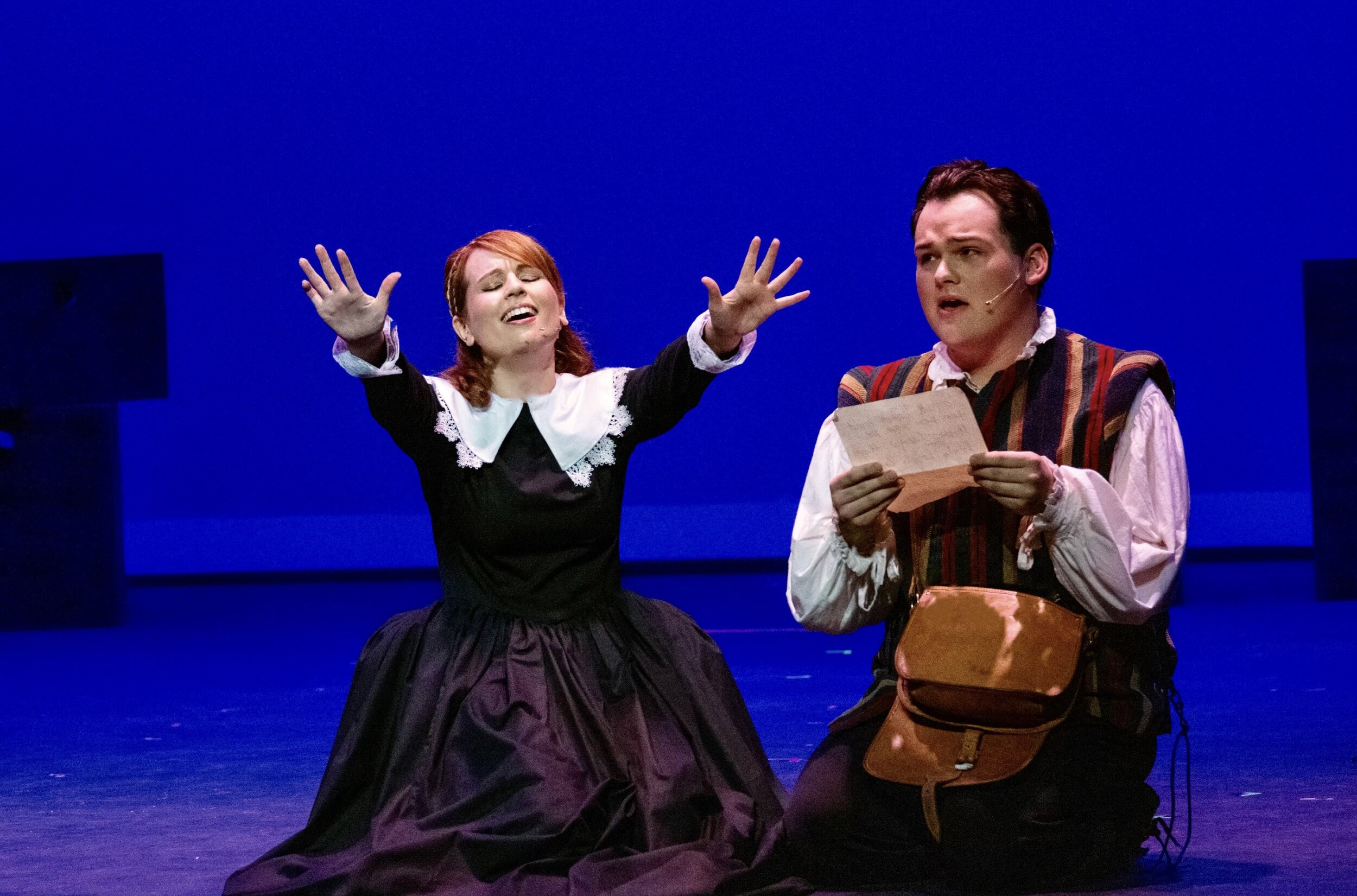 Portia and Nigel "reading" poetry. Something Rotten. Act 1, Inc. PC: Two by Two Photography.