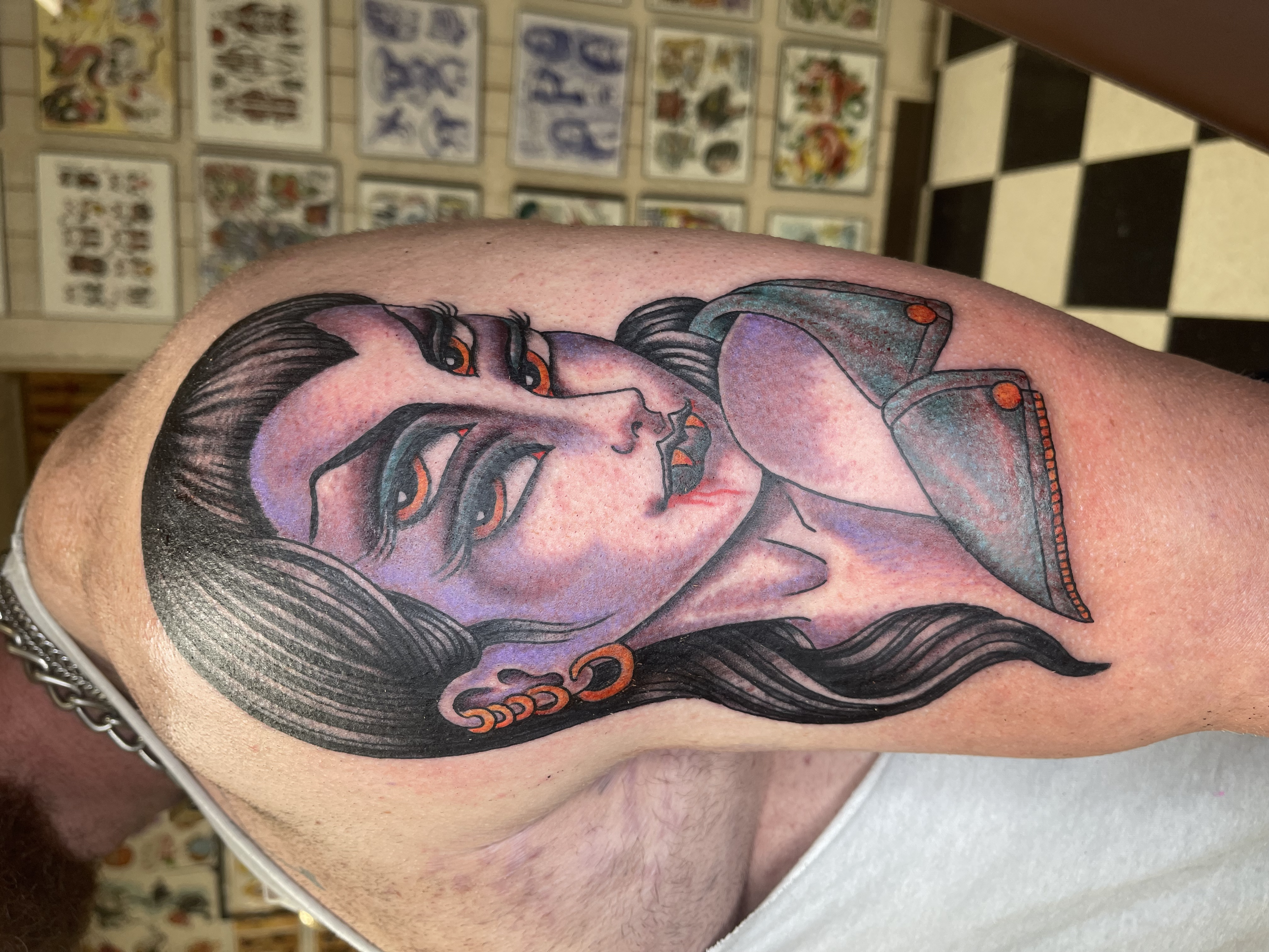 Tattoo of a woman with long wavy hair and a thoughtful expression on her face.