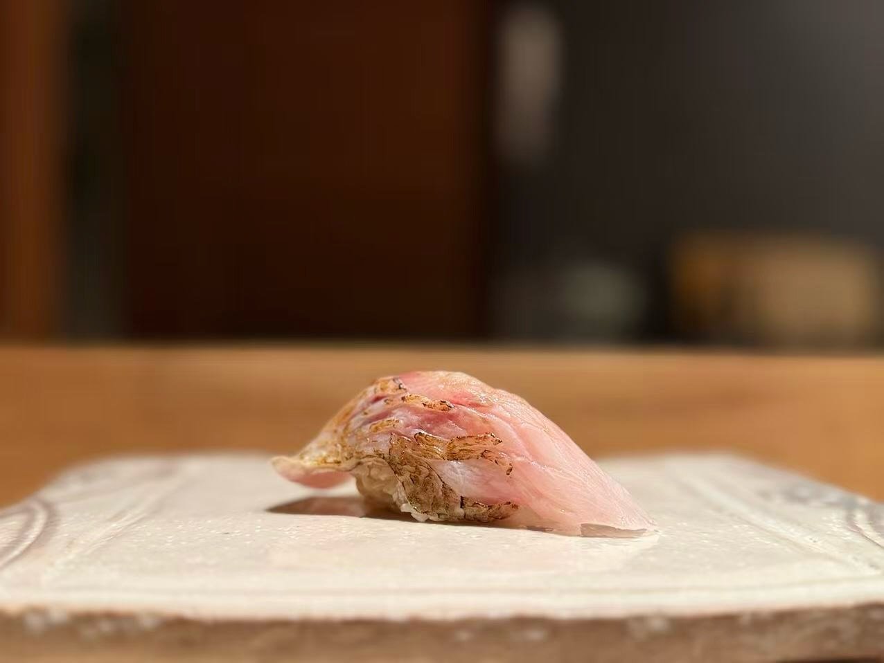Tancho Omakase: Rosy Sea Bass. Akamutsu, also known as Nodoguro.
Lightly torched on the skin to bring out its beautiful aroma, this fish is prized for its incredibly rich flavor, deep natural oil, and luxurious texture. Bold, fragrant, and deeply sat
