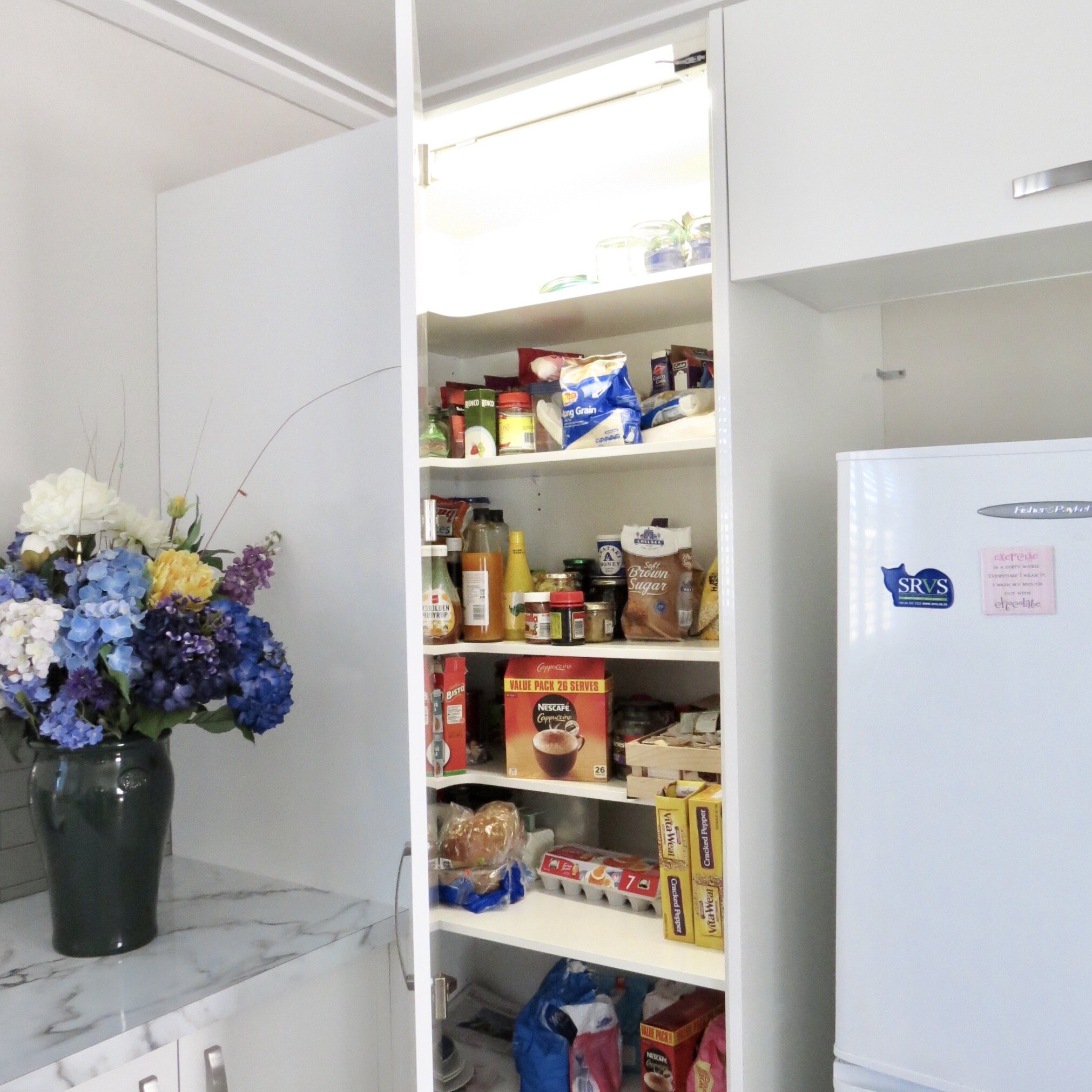 Blind corner pantry with shaped shelves