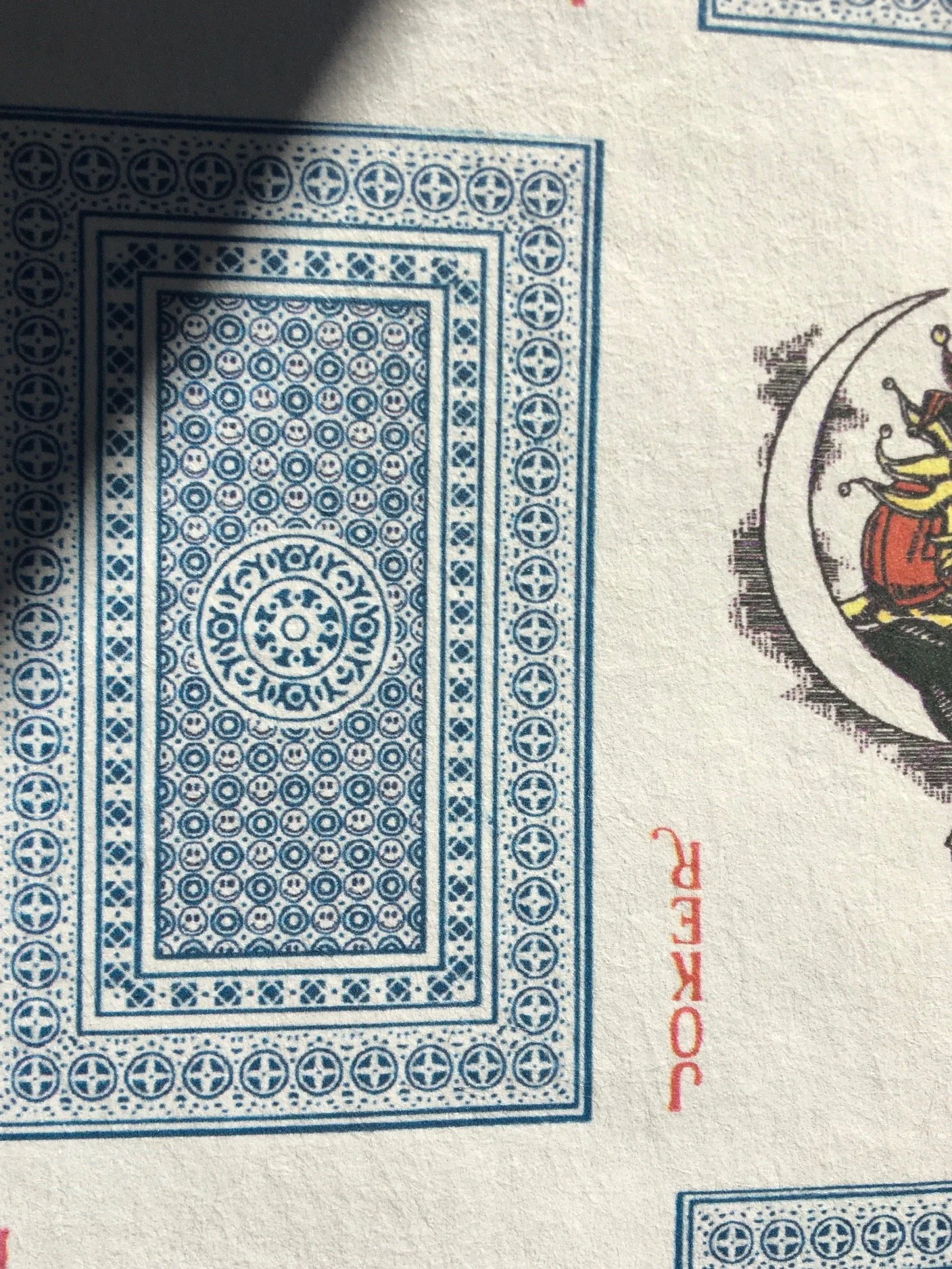tiny smiley face hiding in the playing cards
