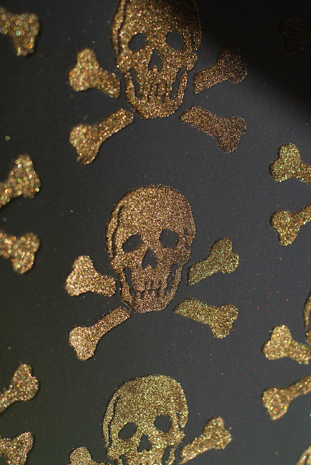 gold velvet skull motif on a black wallpaper background