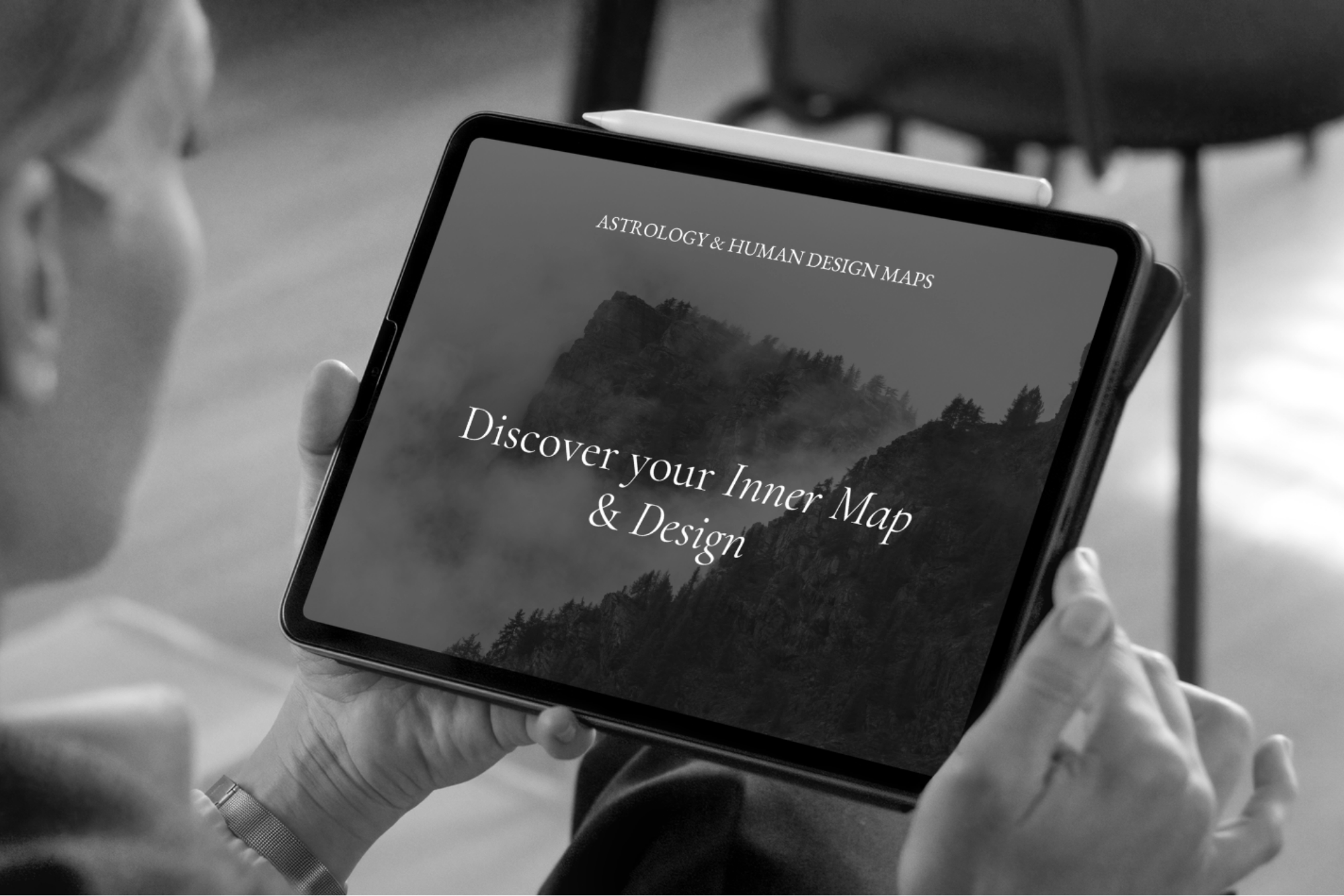 Person holding a tablet displaying Astrology and Human Design maps, an introduction to the Personal Maps collection by Incharge Wellbeing.