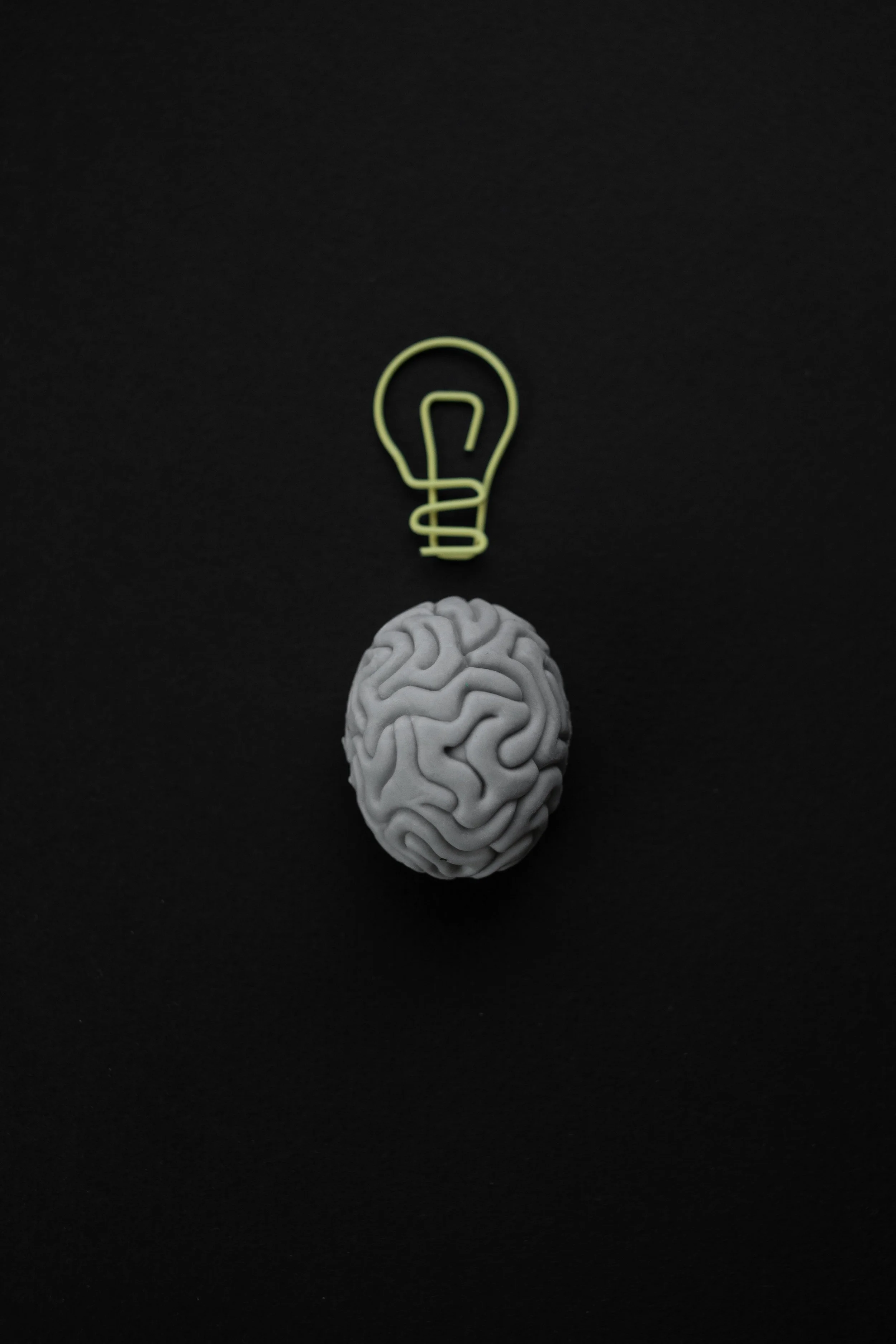 Brain shaped erased with light bulb shaped paper clip