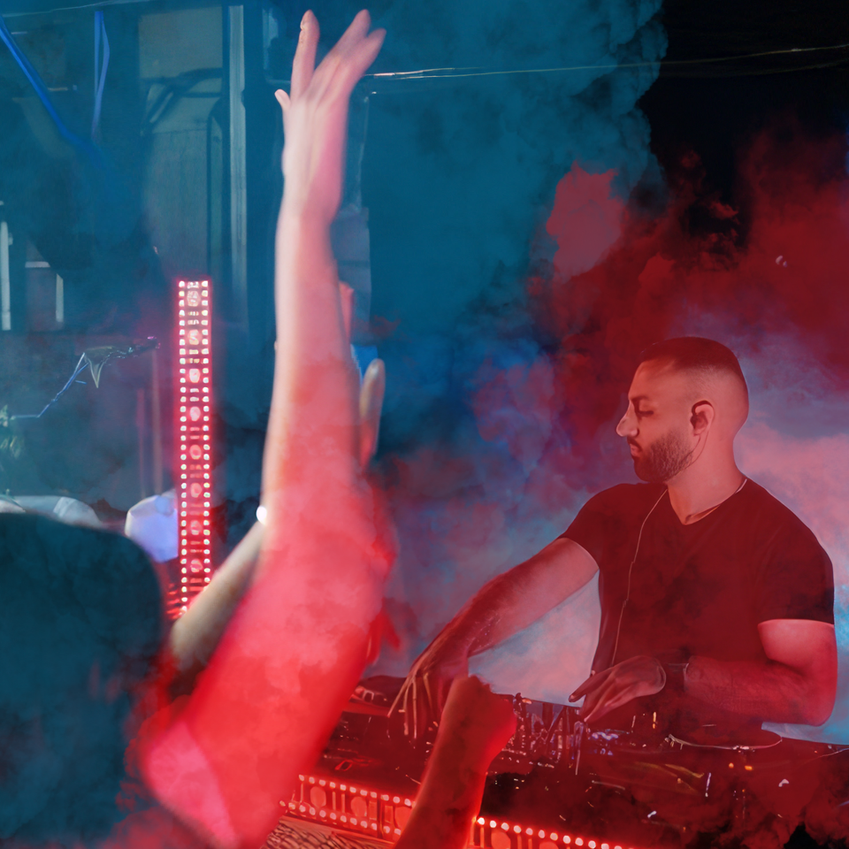 Photo of a DJ on his decks