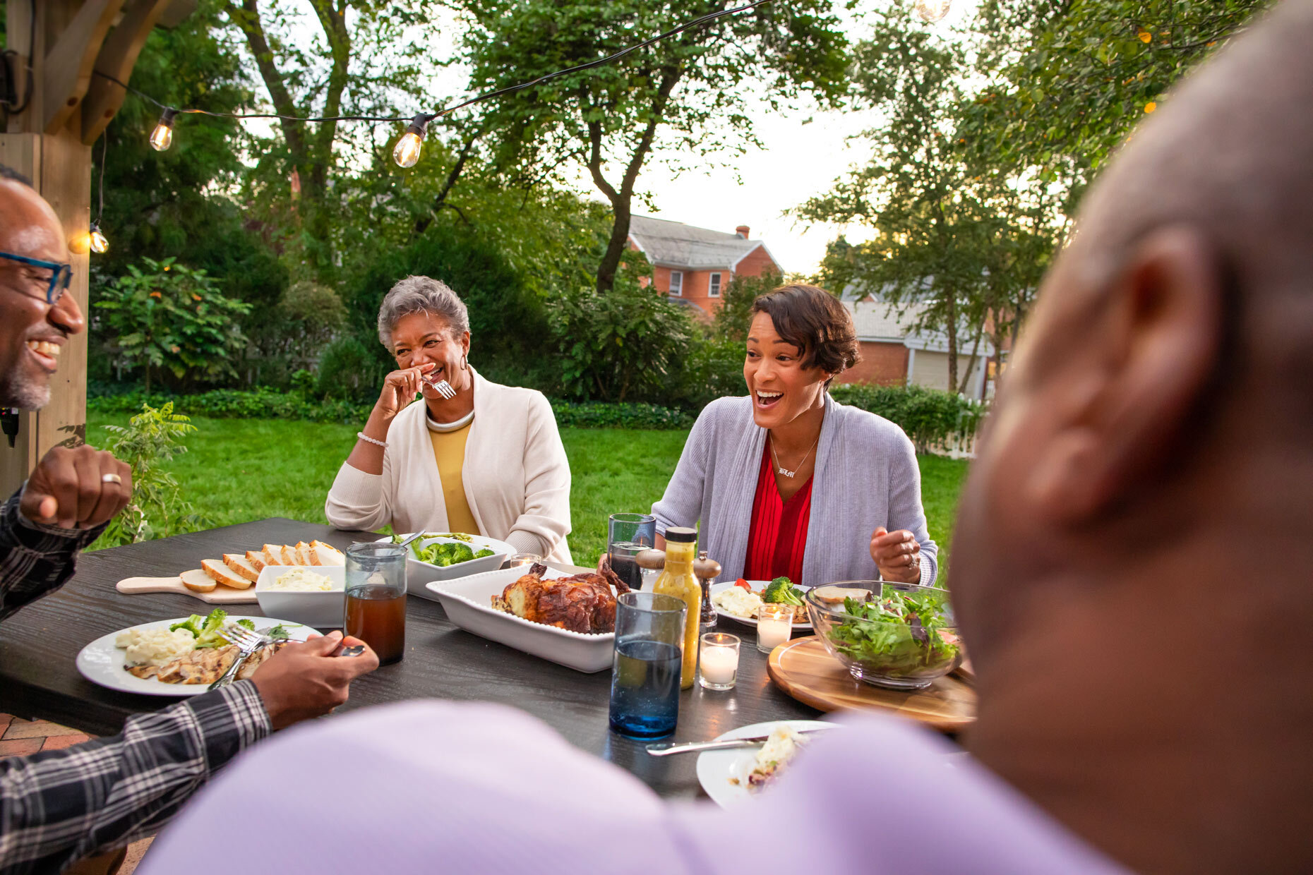 family-eating-dinner-in-backyard_Robert_Holland.jpg