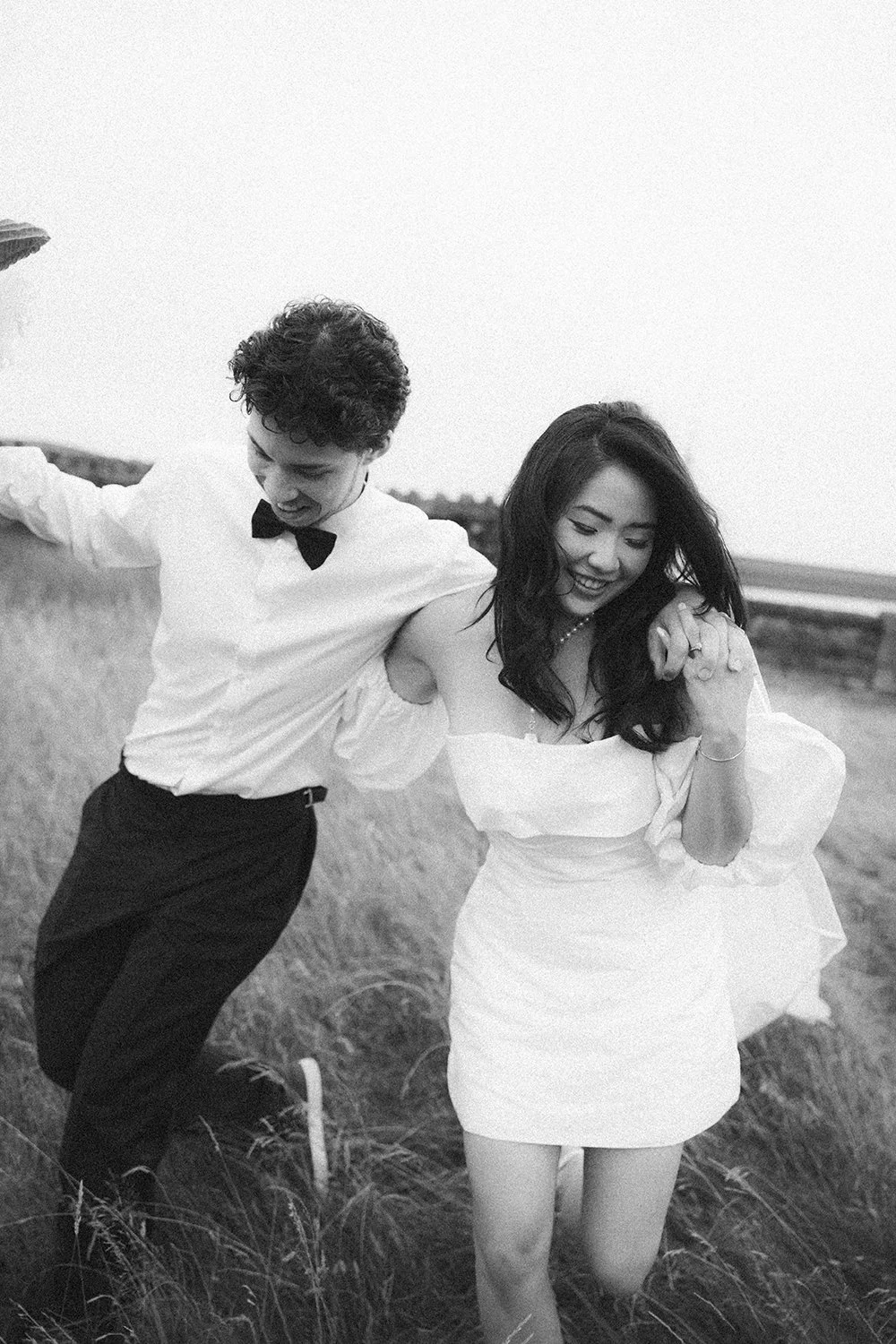 Nicole and Kaiden walking together in the golden hour for their engagement shoot at Scout Moor Wind Farm