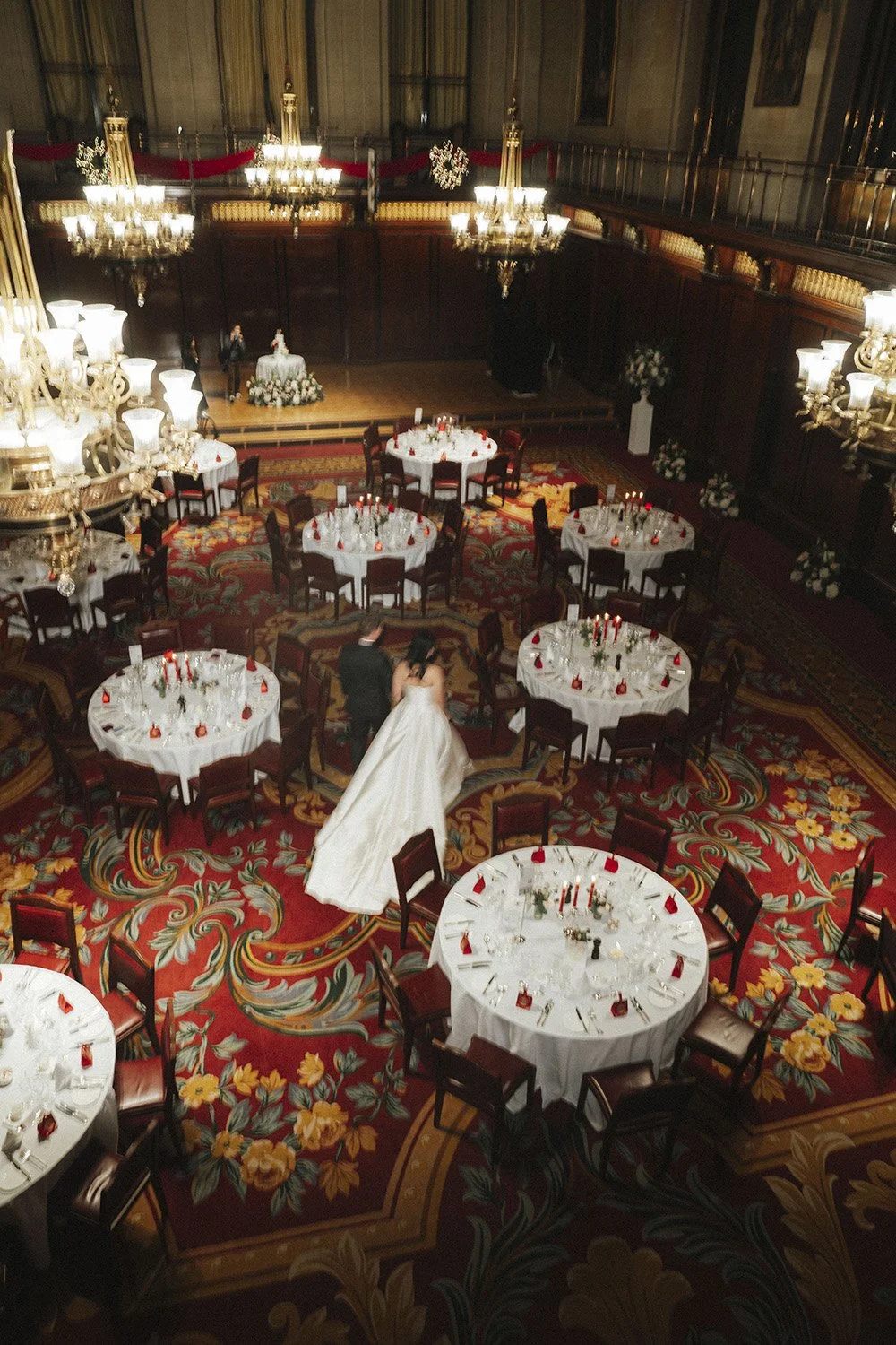 KaMan & Thomas walking around their wedding reception room at Merchant Taylors Hall