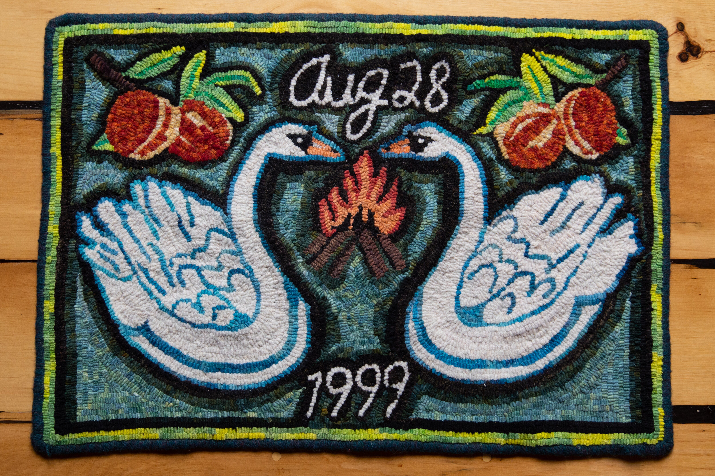 Marriage Rug, 2018, 26 x 18 IN, hand hooked wool on linenPart of Tarot Lovers exhibition 2018Wellington County Museum, Aboyne, OntarioAugust 28th, 1999. We were married in a peach orchard, swans embossed on our invitations, an evening fire, a baby in my belly. My rug is simple. My love is unconditional.