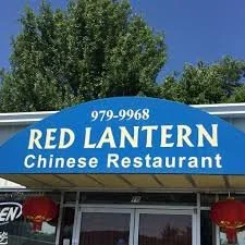 Sign for Red Lantern Chinese Restaurant with phone number 979-9968, outdoors with trees and blue sky