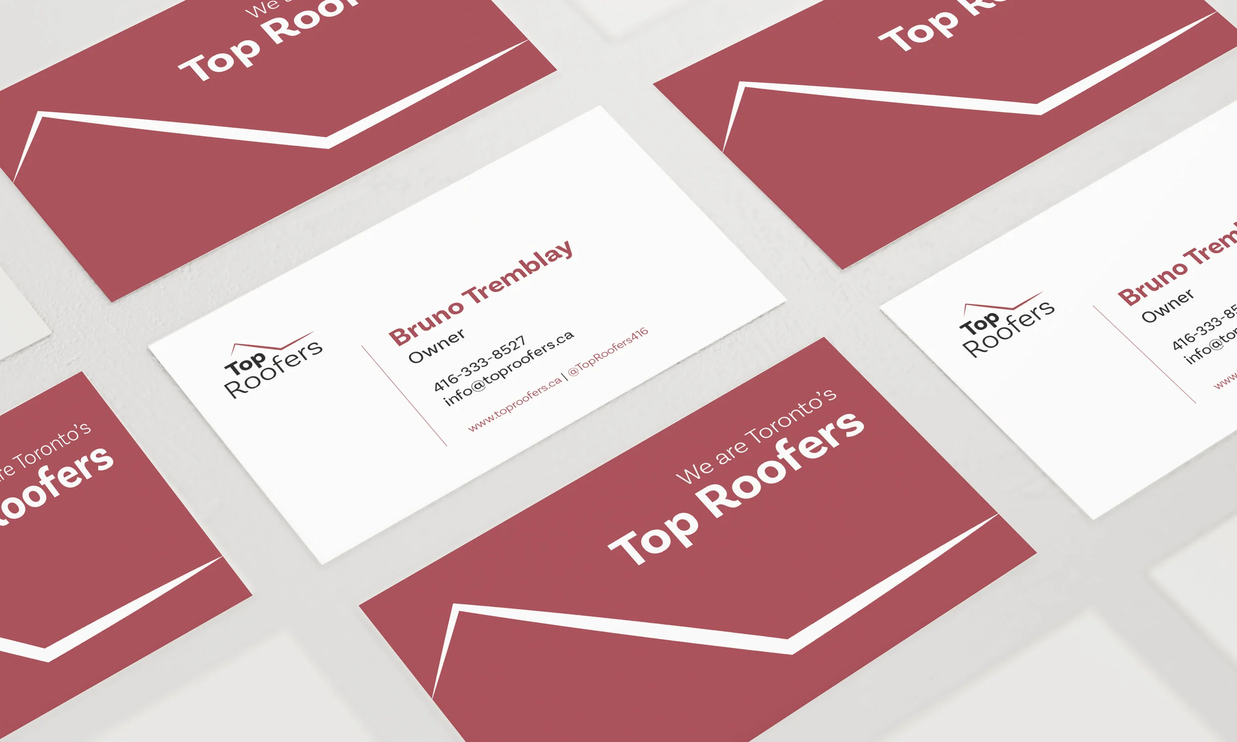 Business cards for Top Roofers, a roofing company, featuring the name, logo, contact information, and slogan.