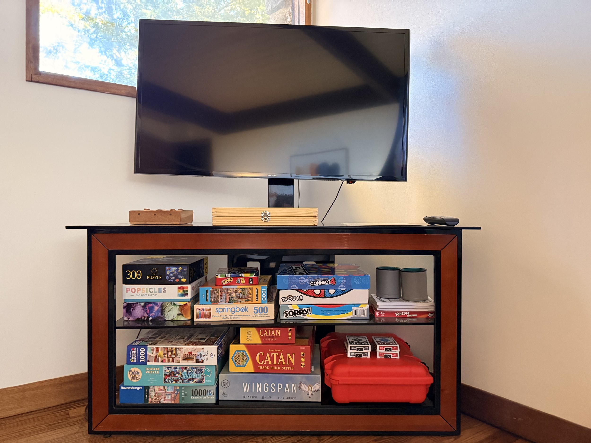 Entertainment console with board games, television, and retro activities