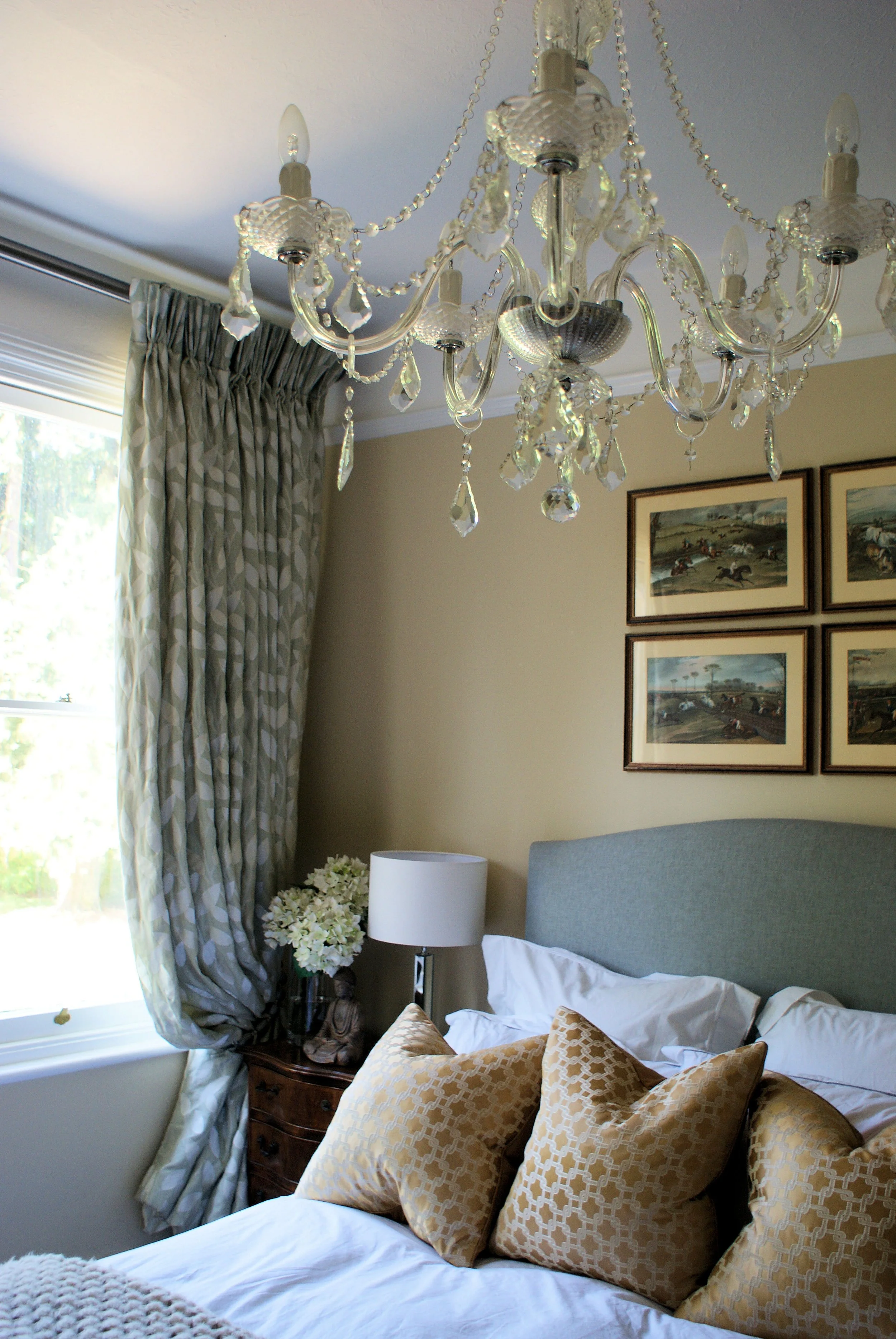  A muted colour palette to the soft furnishings to compliment the antique crystal chandelier &amp; framed landscapes. 