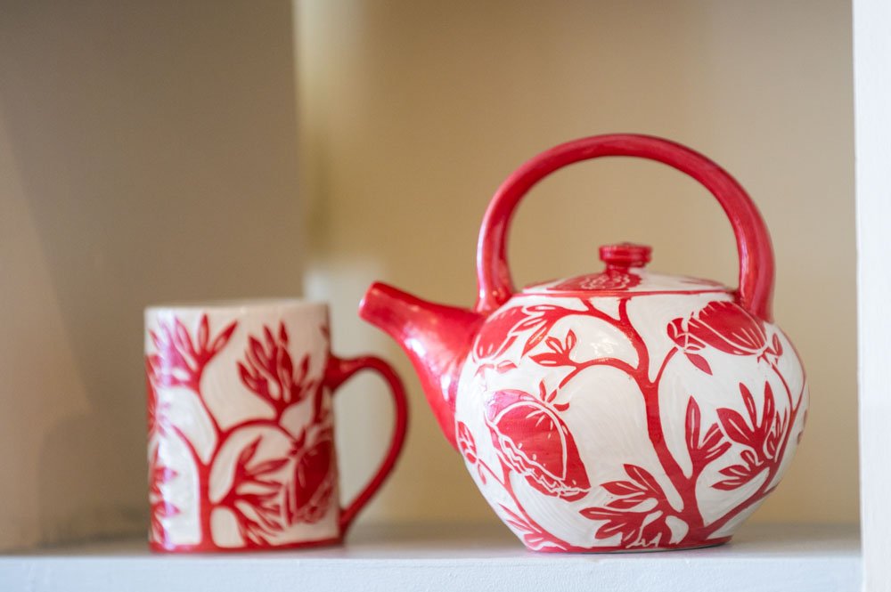 Ceramic tea pot and mug with floral designs