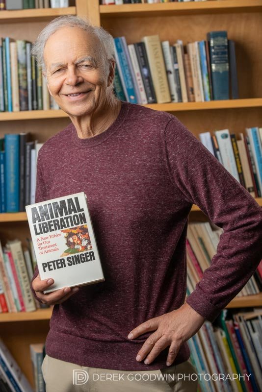 Peter Singer holding original copy of Animal Liberation