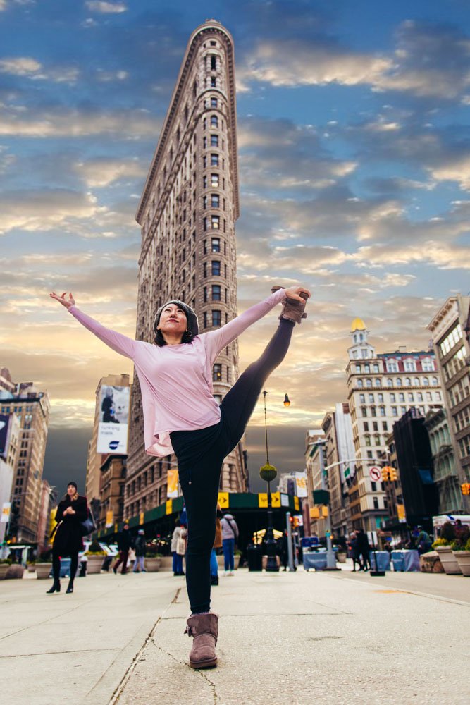 Yoga pose with the Flat Iron building in the background