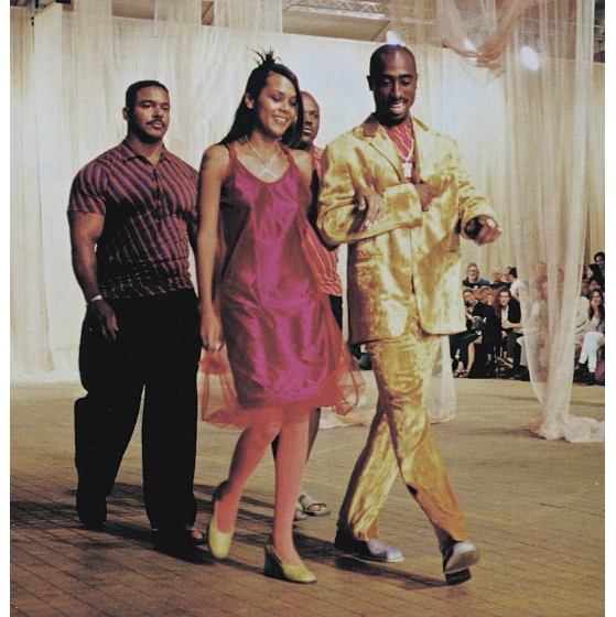 Tupac Shakur & Kidada Jones with bodyguards at Romeo Gigli Fall 1996 in Milan, Italy. July 1, 1996.png