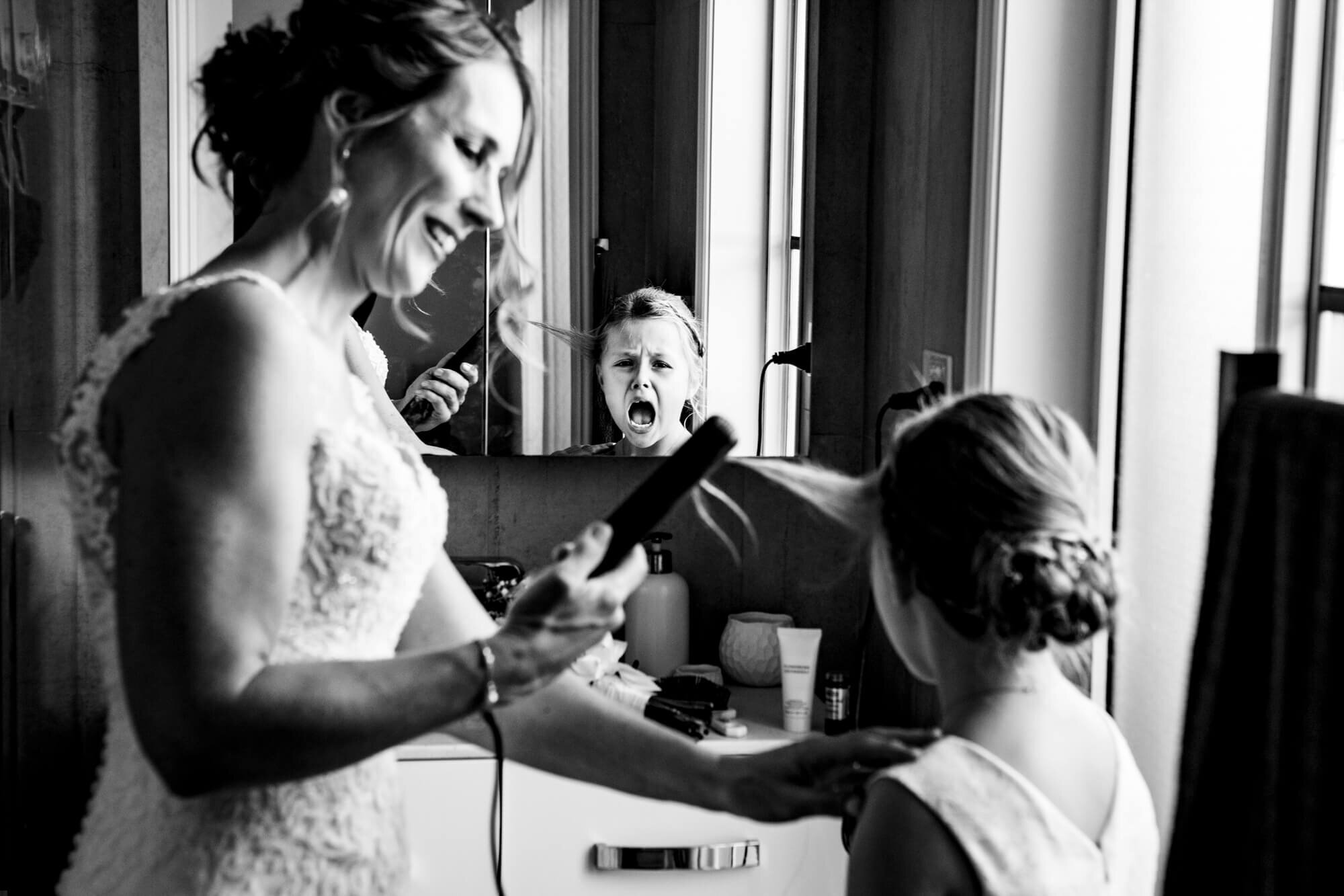 Black and white photo of flower girl getting ready