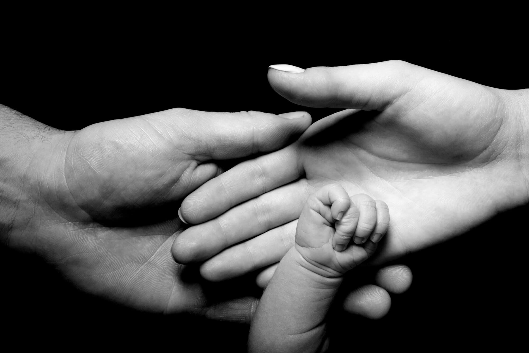 Newborn photoshoot with parents hands
