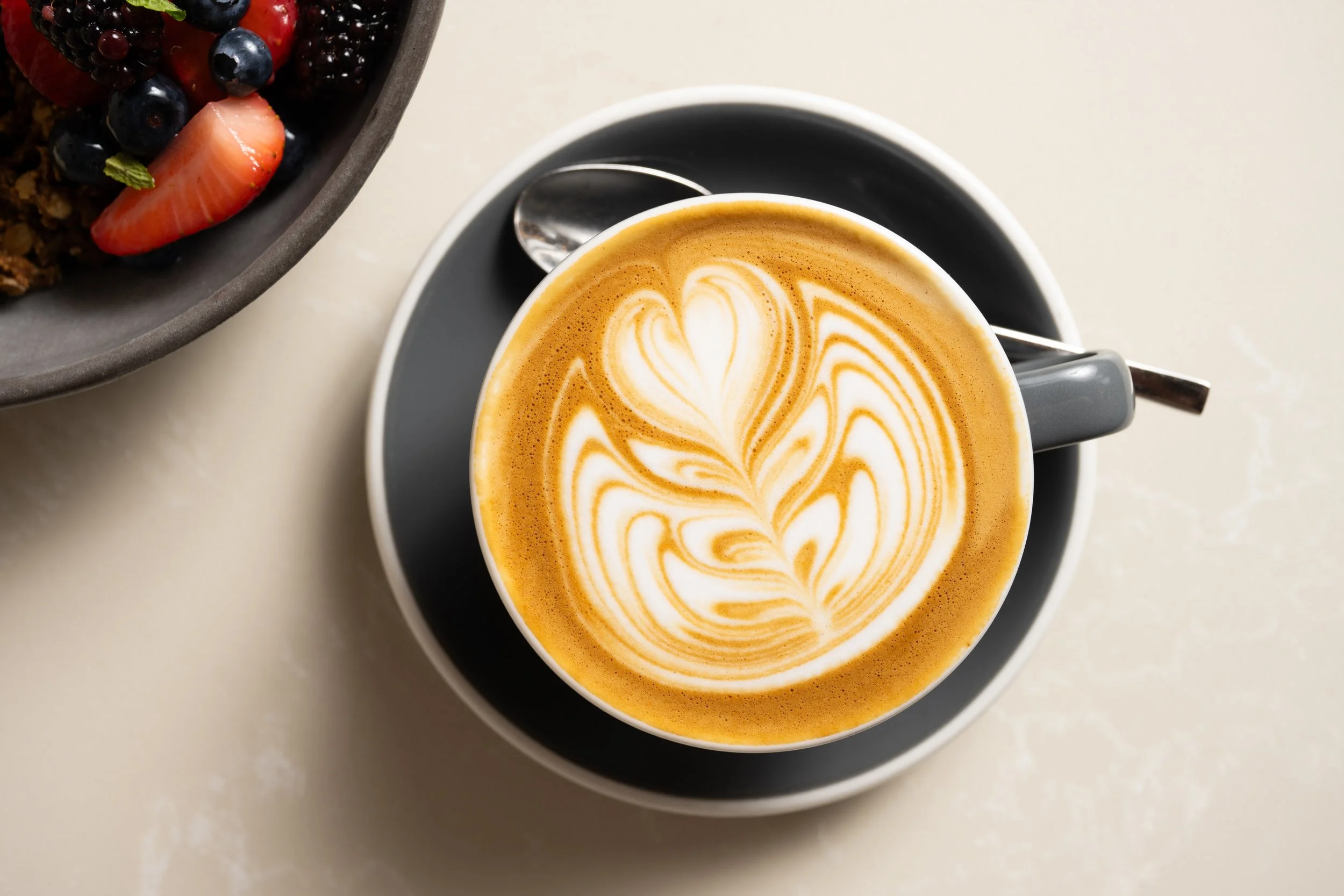 A group of people drinking coffee from a cafe near Midtown, NY.
