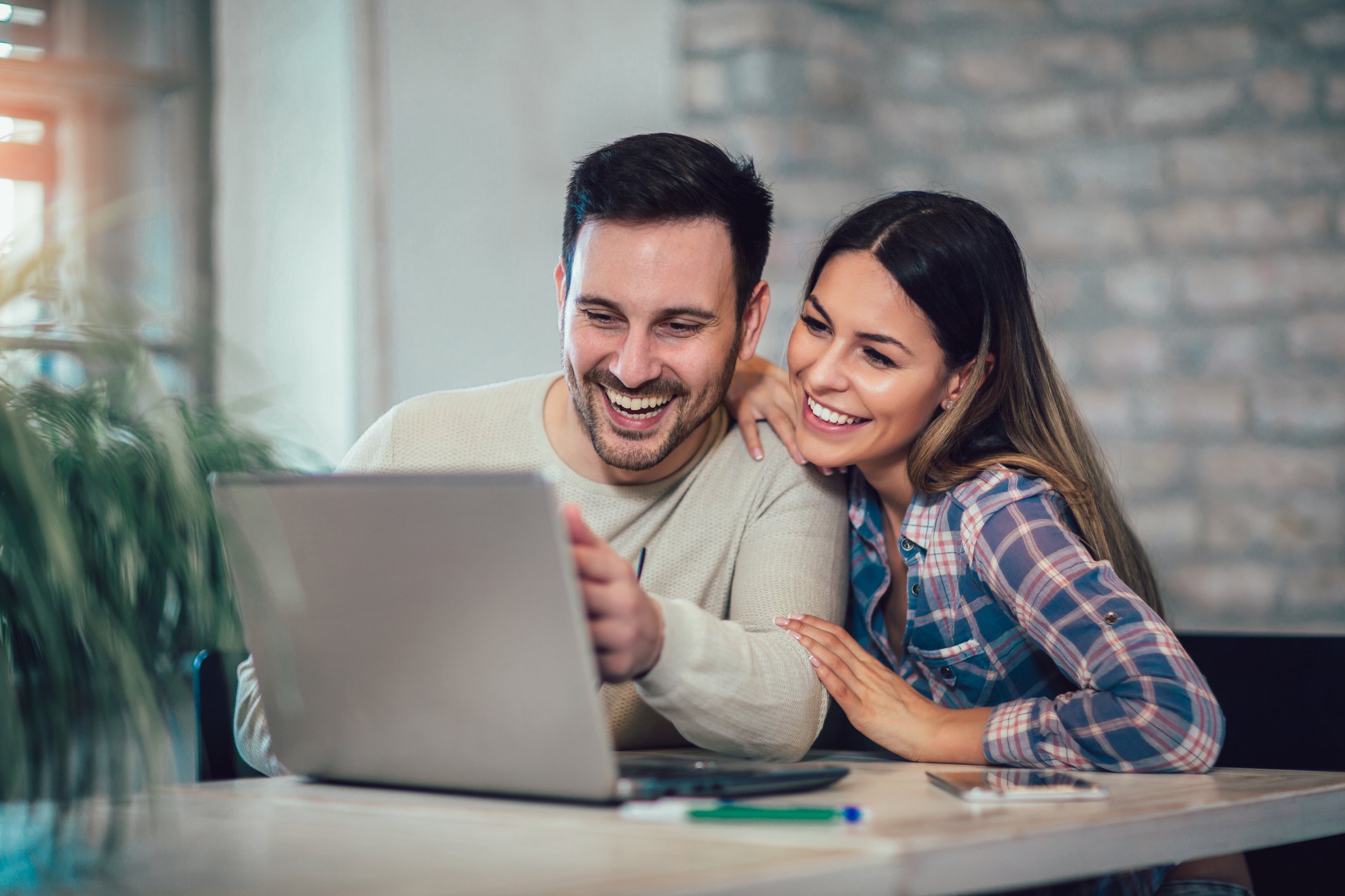 Couple sitting together at home, representing connection and relationship repair in couples therapy.