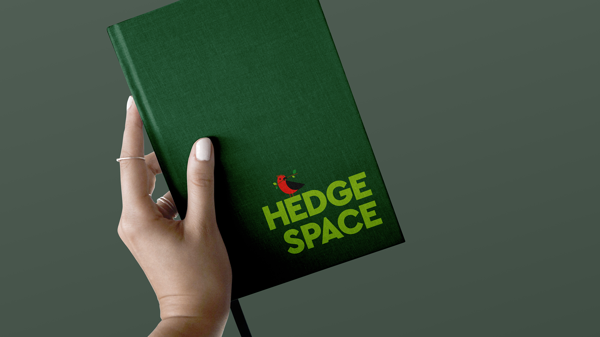 Hard-Cover-Notebook-with-Hand-Mockup.png