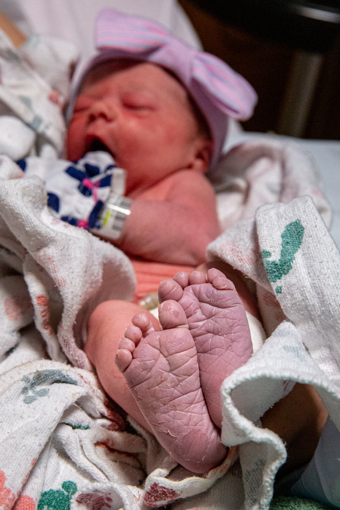 A newborn baby's pink, wrinkly feet.