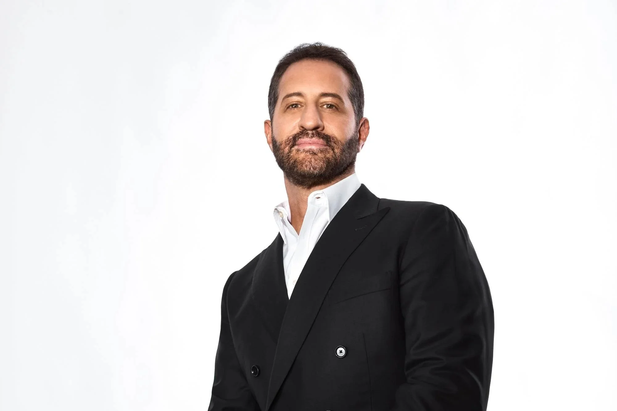 Modi Rosenfeld in a black suit, looking right at the camera.