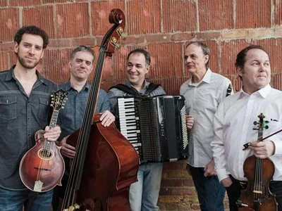 Beyond the Pale musical group posing to the camera and holding their instruments