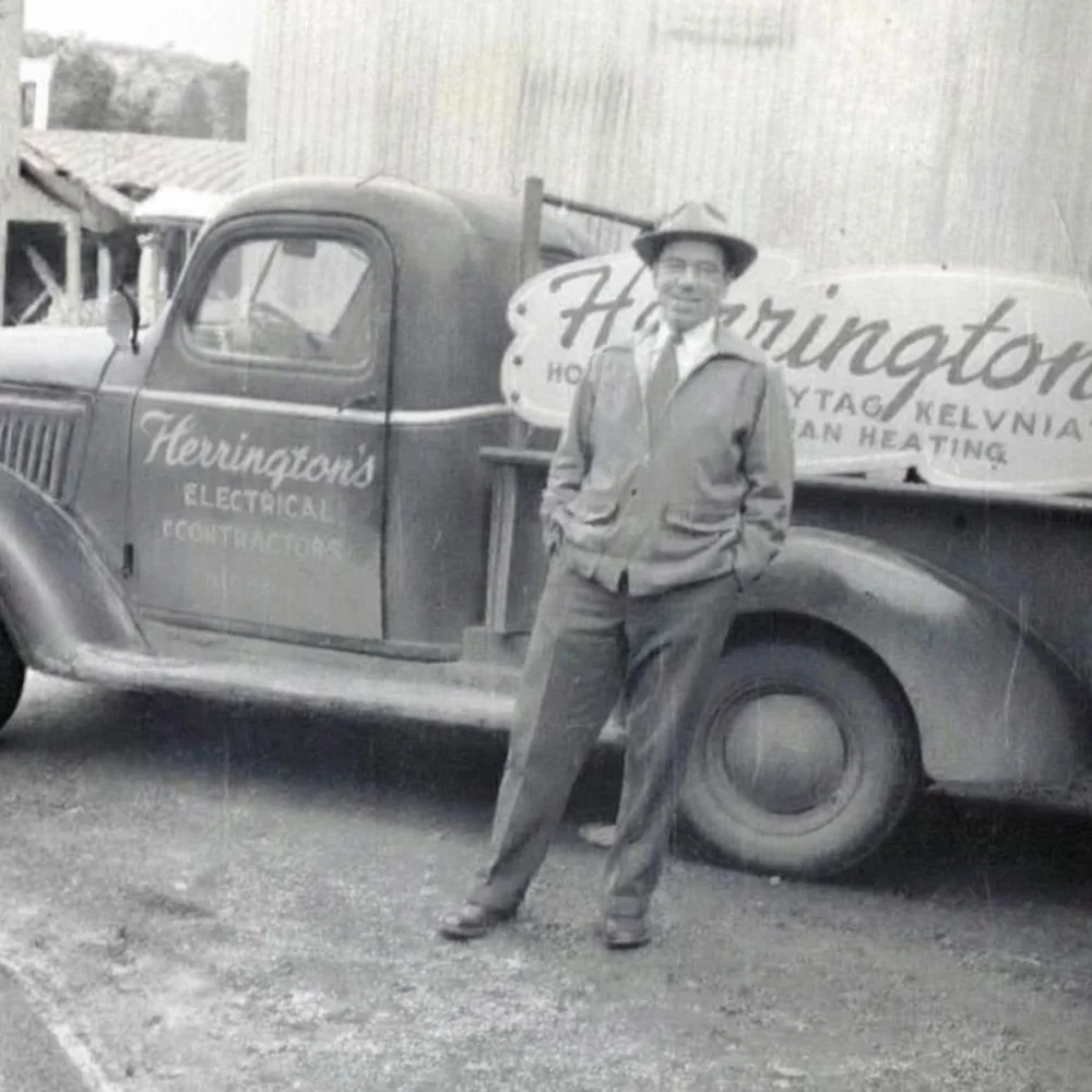 Grandpa George in front of Herrington's Electrical Contractors truck