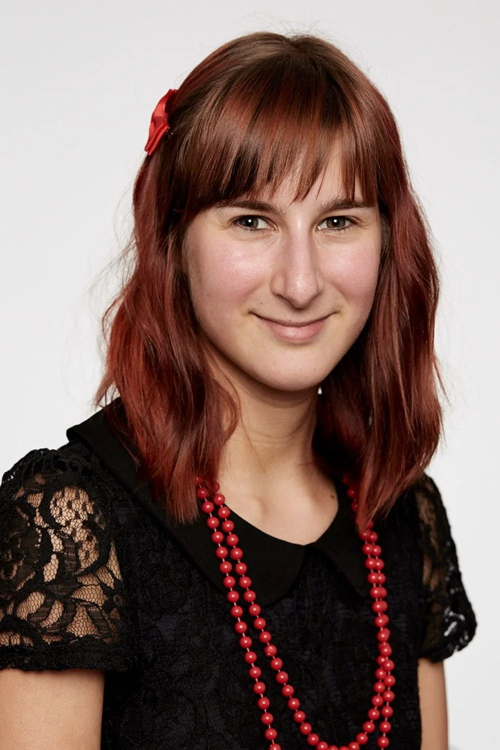 Sarah in her early days as a graphic designer with red hair and fancy clothes