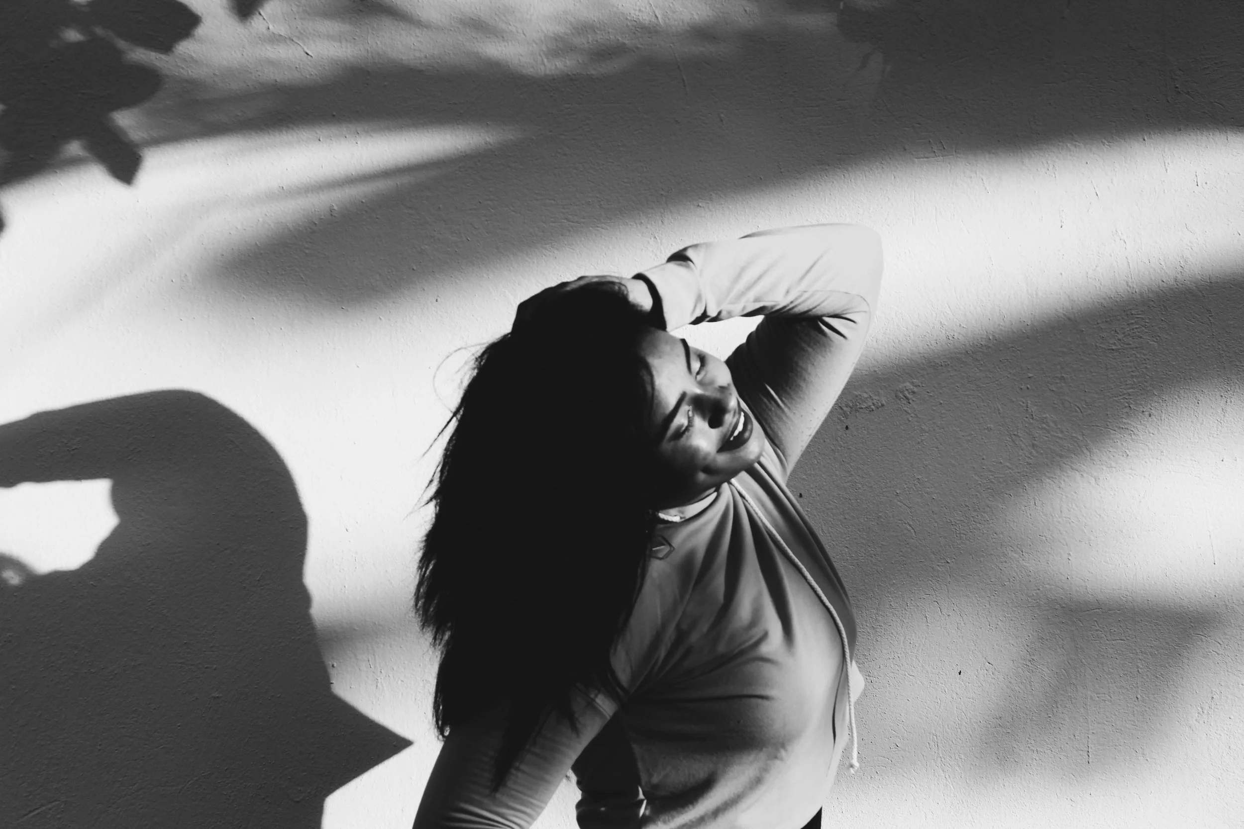 A woman holding her hair while posing for a photo. Explore the inner critic with the help of an eating disorder therapist in Asheville, NC. Work on healing your body & relationship with food!