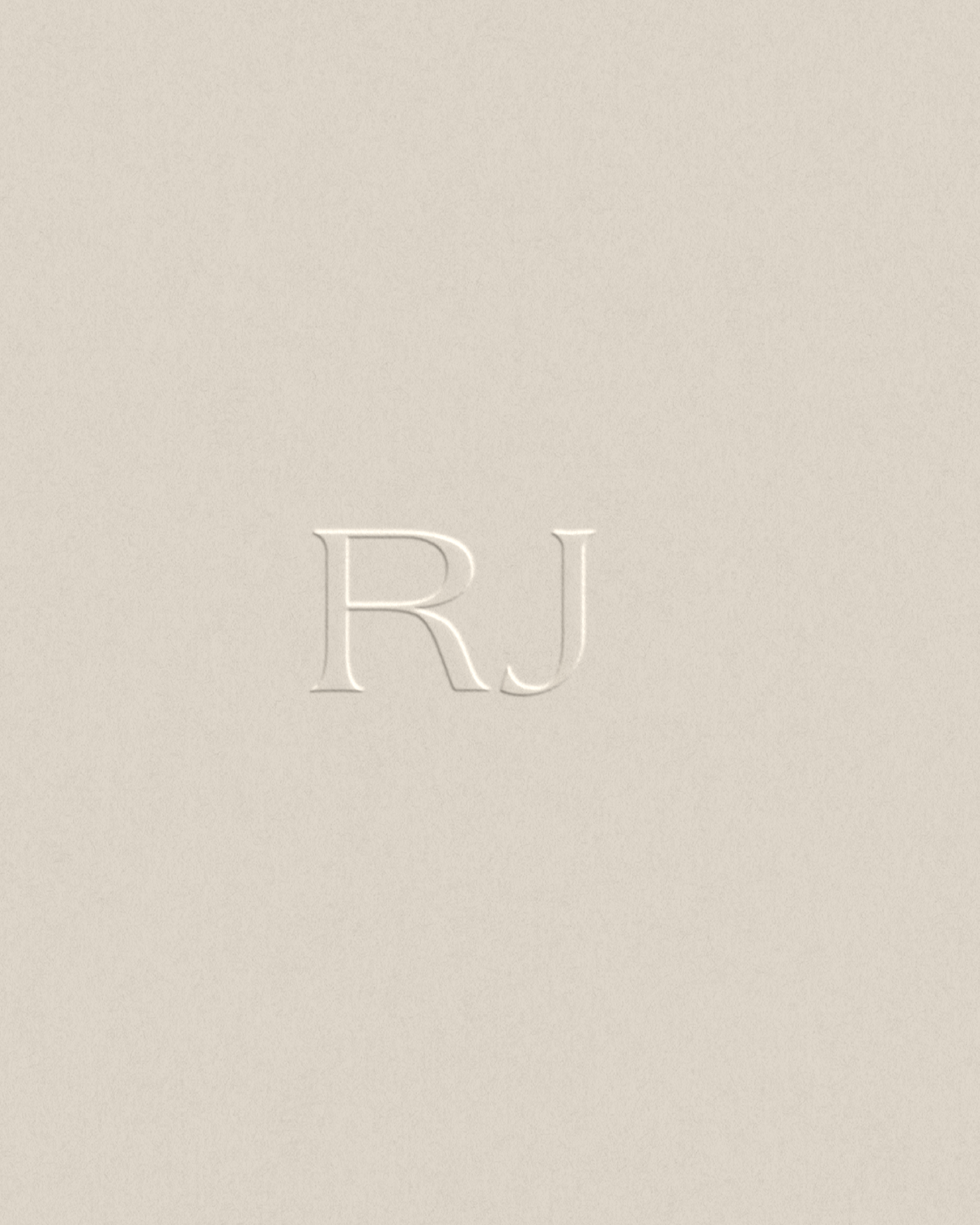 Embossed RJ initials on neutral background