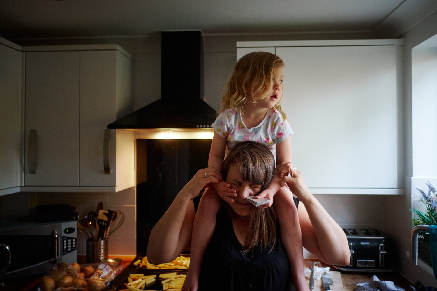 Documentary Family Photography in Dorset - Daisy squashing grannies face