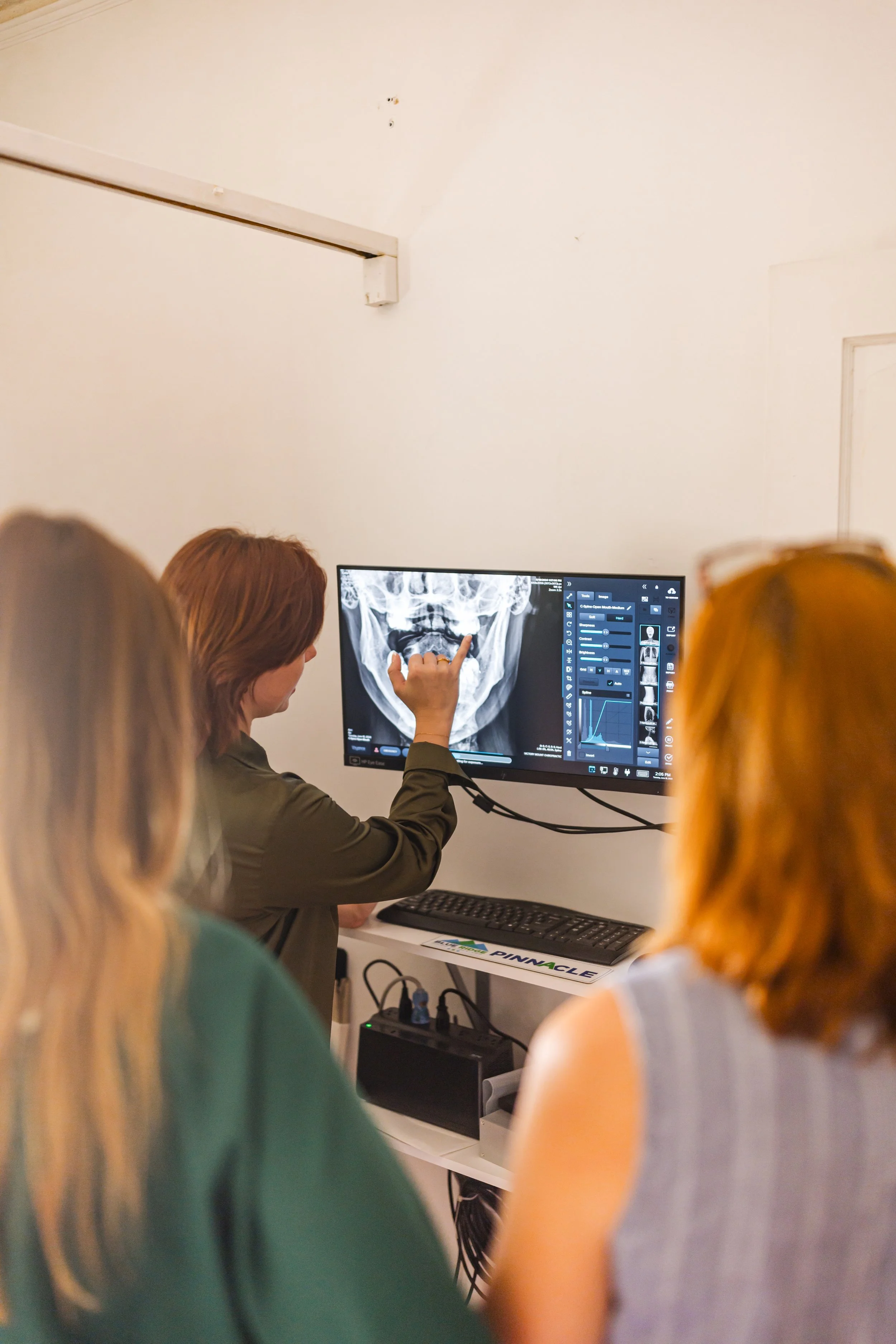 Dr. Victoria explaining x-ray findings to patients.