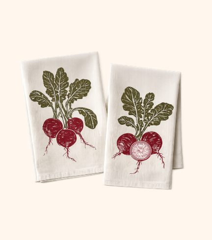 Two white kitchen towels with vintage-style illustrations of radishes, one showing a bunch with leaves and the other with a sliced radish.