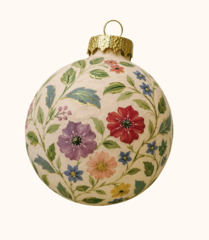 Decorative Christmas ornament with a floral pattern and gold cap.