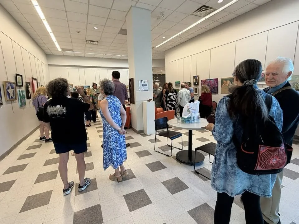 Reception crowd enjoying art work