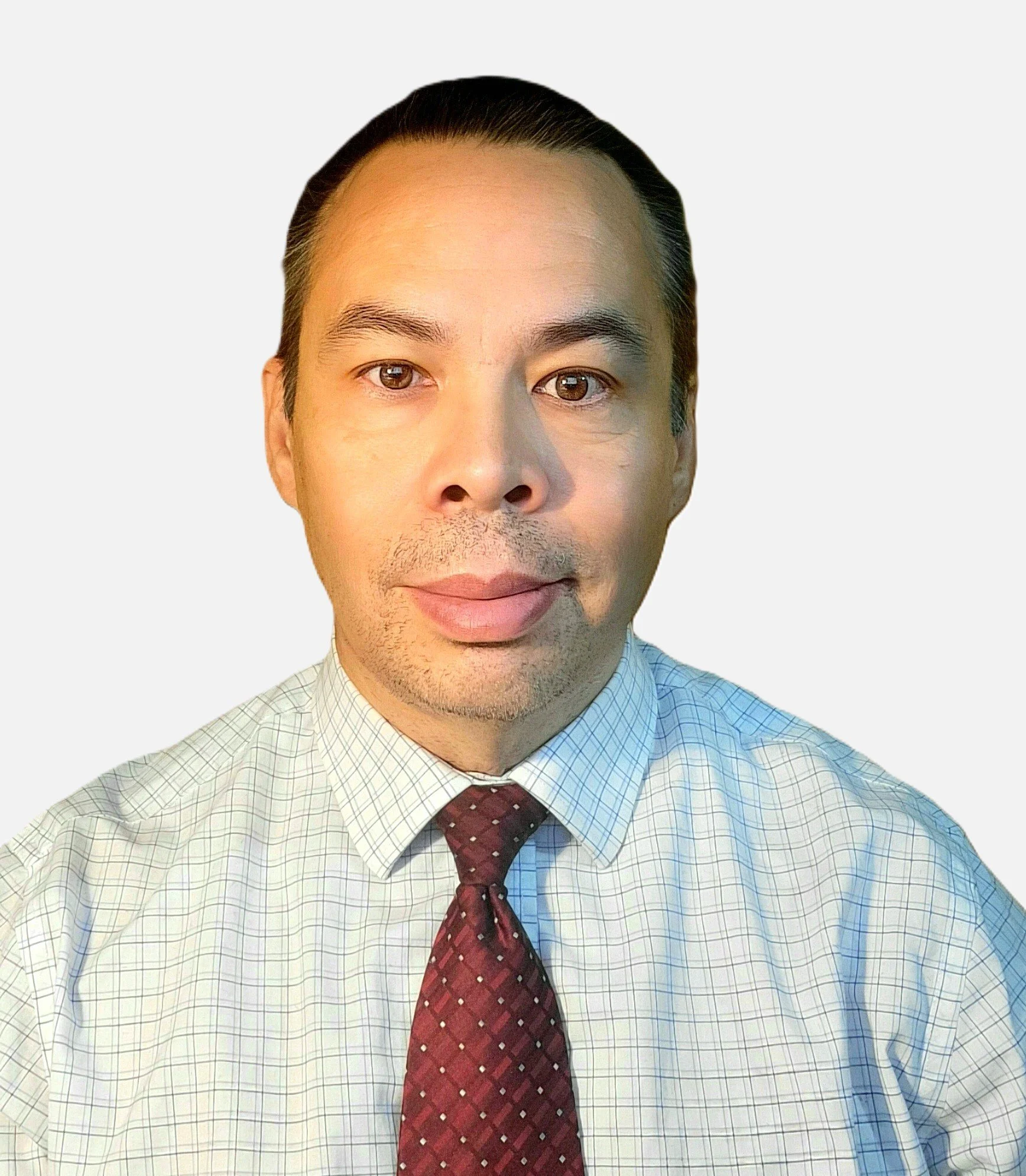 A man with short dark hair wearing a white collared button up with a pattern paired with a dark red tie with yellow dots on it.