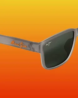Gray sunglasses with an orange Mon Juju logo on the arm, set against an orange and yellow gradient background.