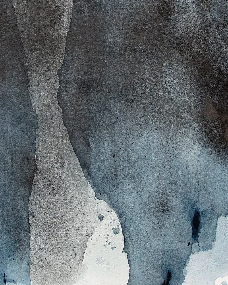 Abstract watercolor painting with dark shades of blue, black, and gray, featuring organic shapes and textured areas.