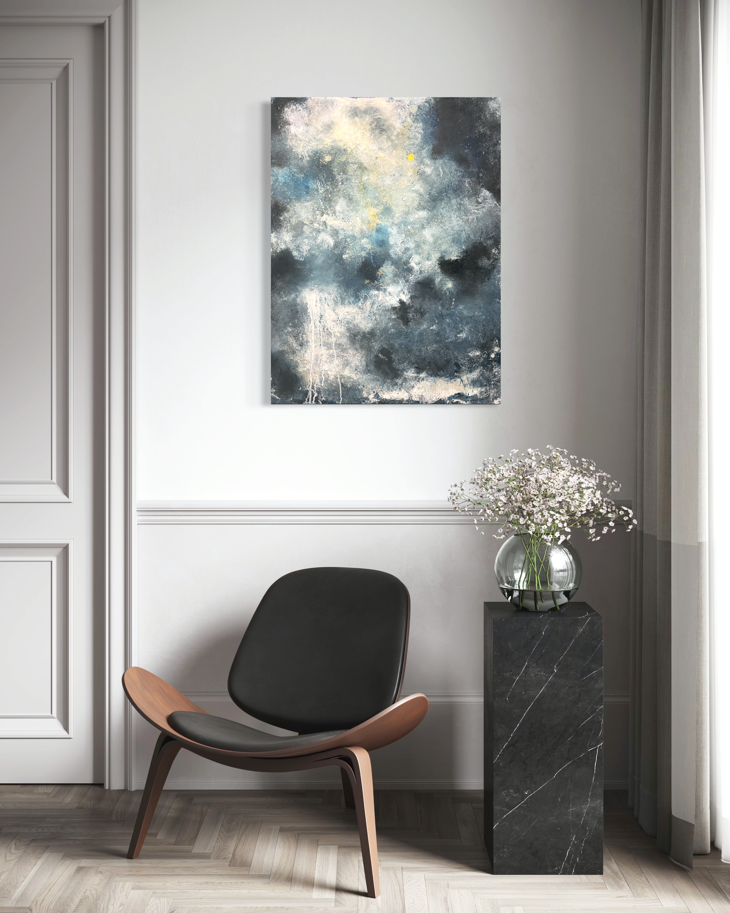 Modern interior scene with a black and white marble side table holding a glass vase with white flowers, a black upholstered chair, a large abstract painting in shades of blue, white, gray, and black on a white wall, a potted plant, and a source of natural light from a window with curtains.