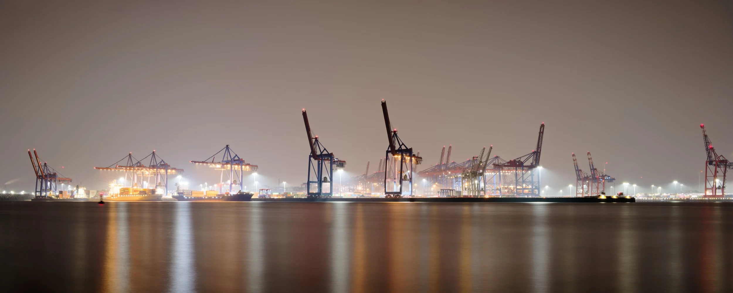 Night panorama of container cranes at the Port of Hamburg, Germany.  Photograph by Douglas Seigars.